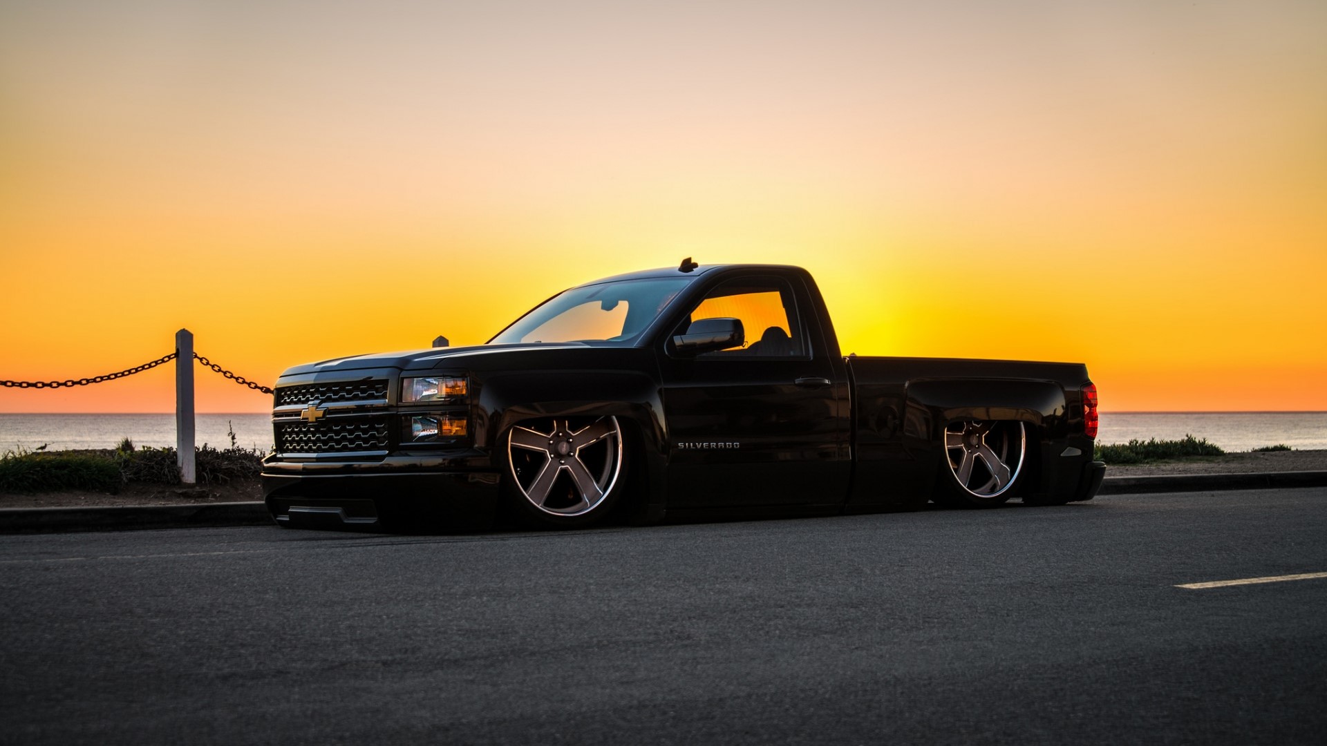 Black Chevrolet Silverado lowered truck at sunset HD Wallpaper