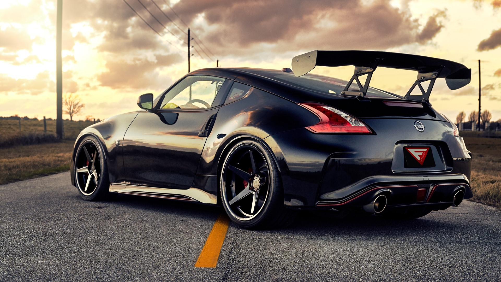 Black Nissan 370Z with a large rear spoiler HD Wallpaper