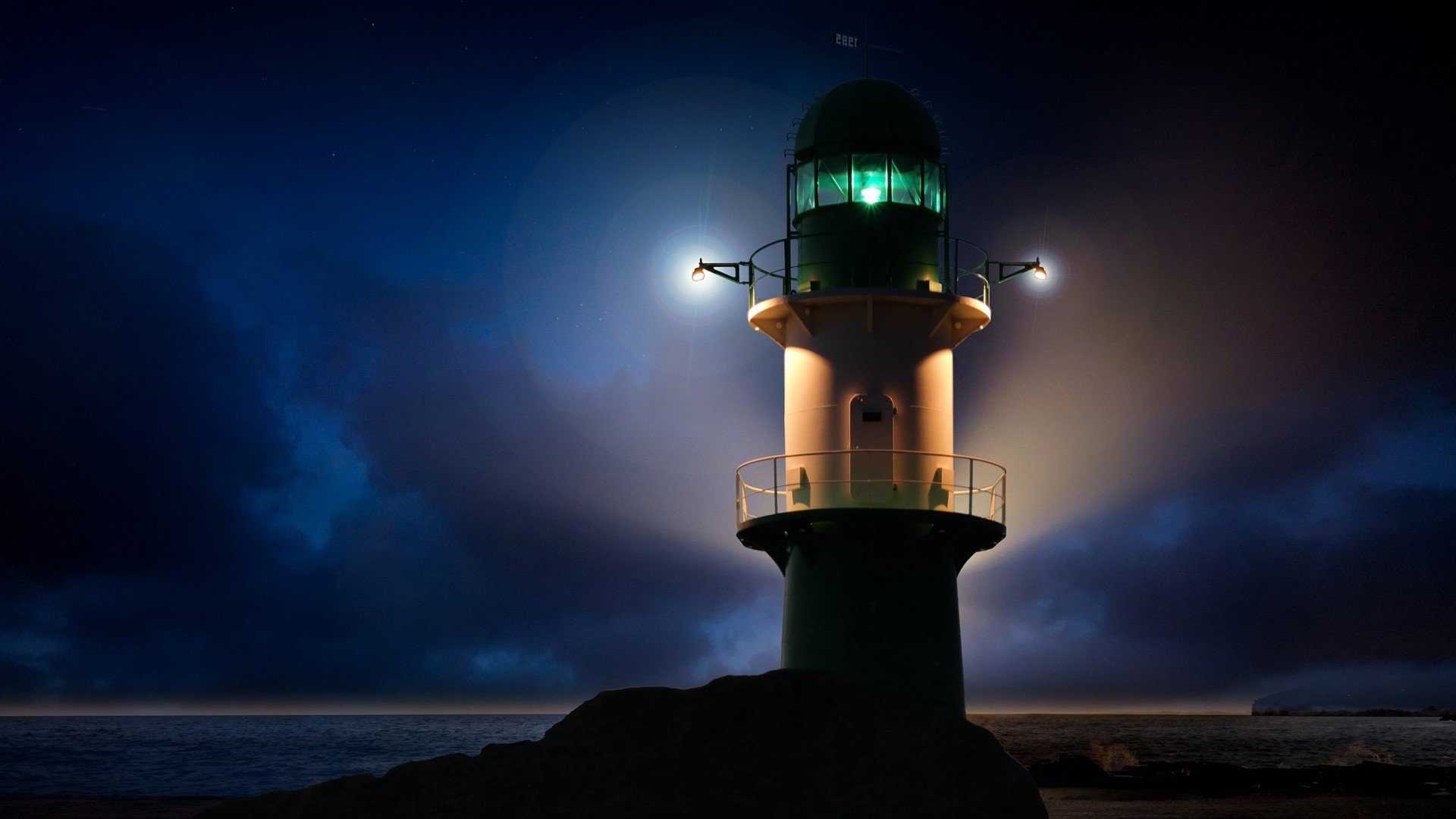 Lighthouse at night with green light HD Wallpaper