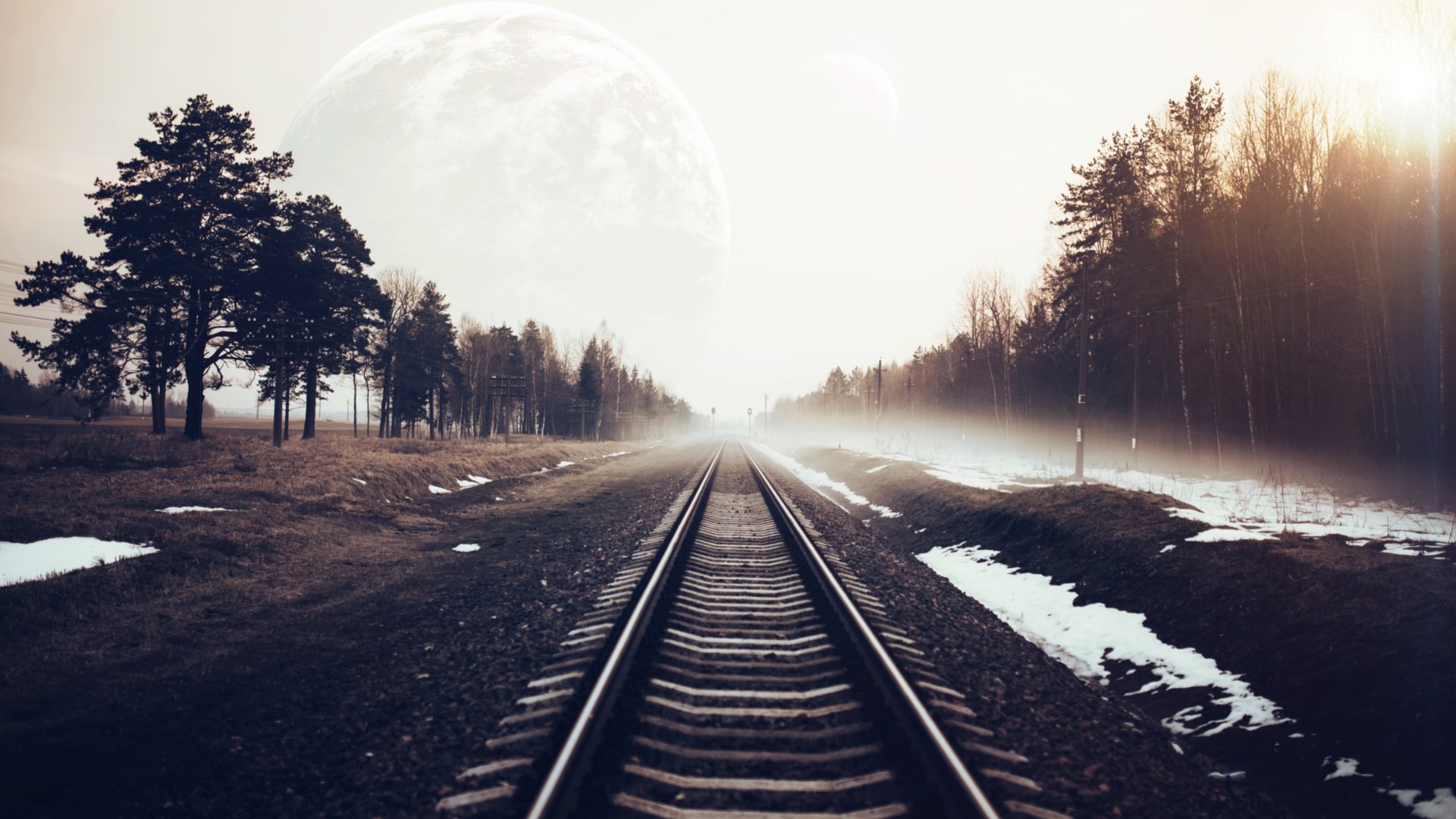 Railway tracks through a misty forest with a large moon HD Wallpaper