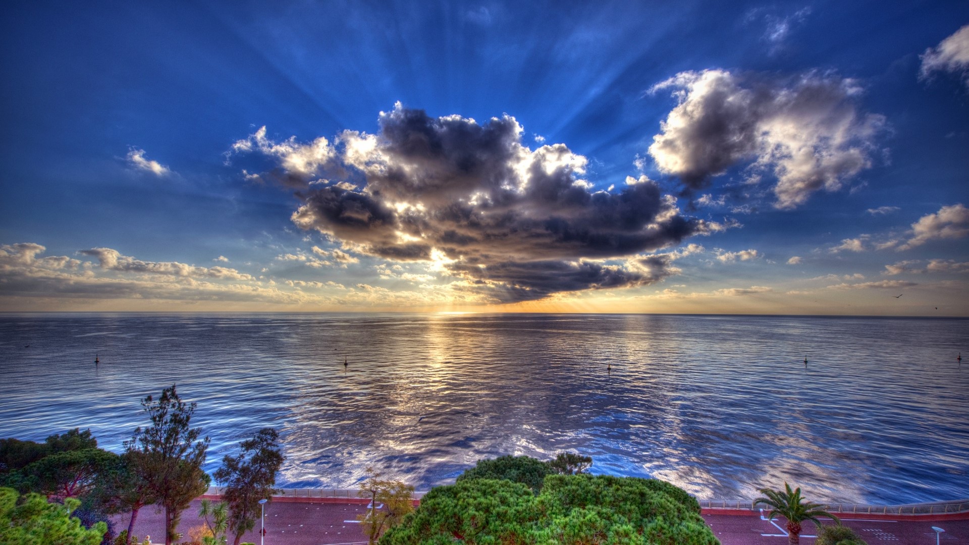 Sunset over the ocean with dramatic clouds HD Wallpaper