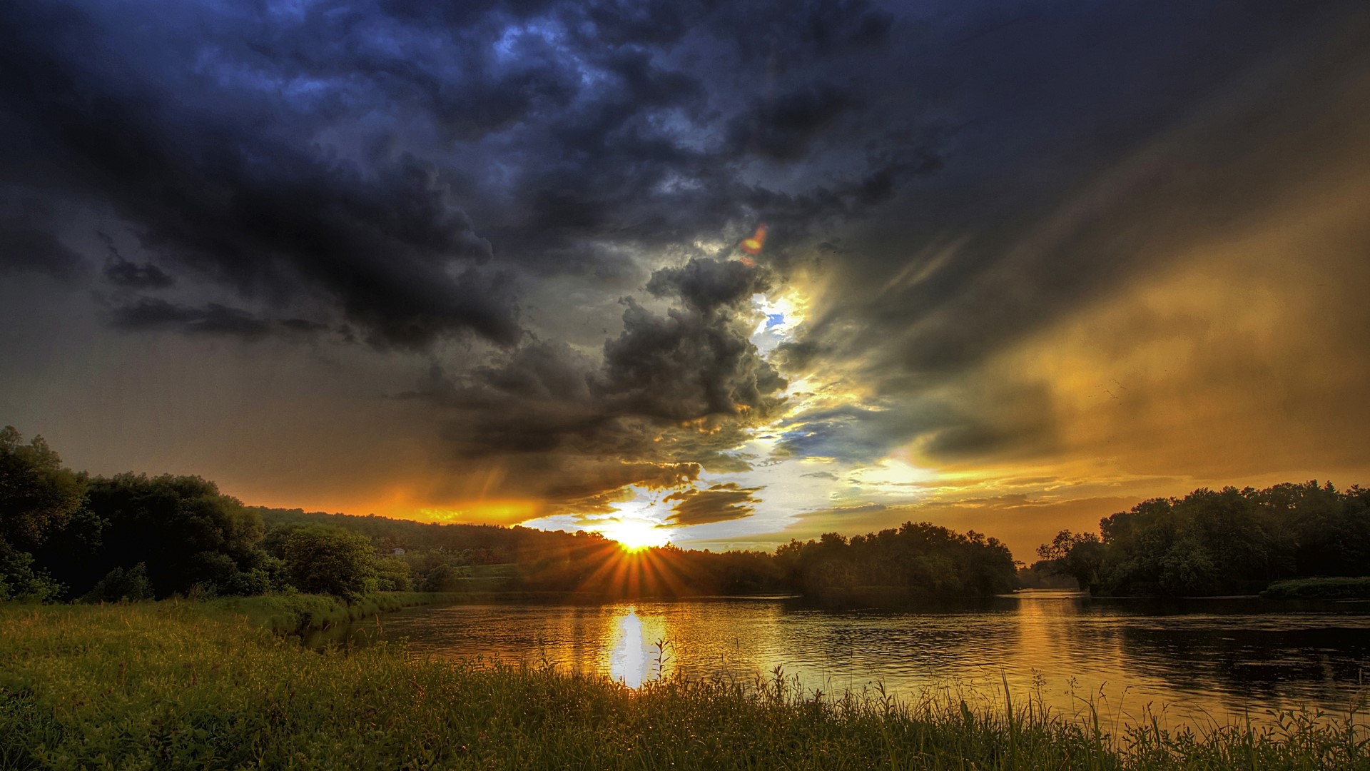 Sunset over a river with dramatic clouds HD Wallpaper