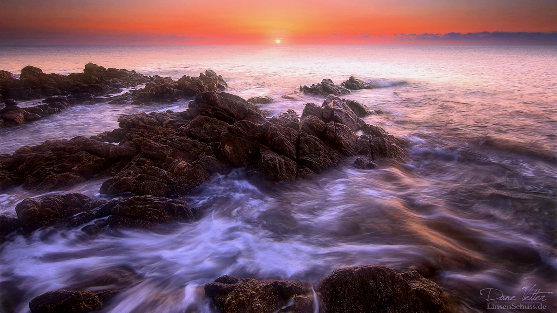Sunset over rocky shore with ocean waves HD Wallpaper