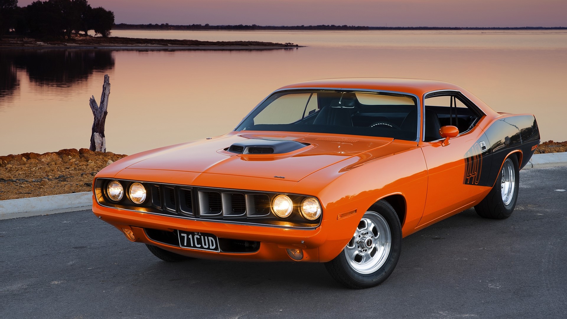 1971 Plymouth Barracuda parked by a lake at sunset HD Wallpaper