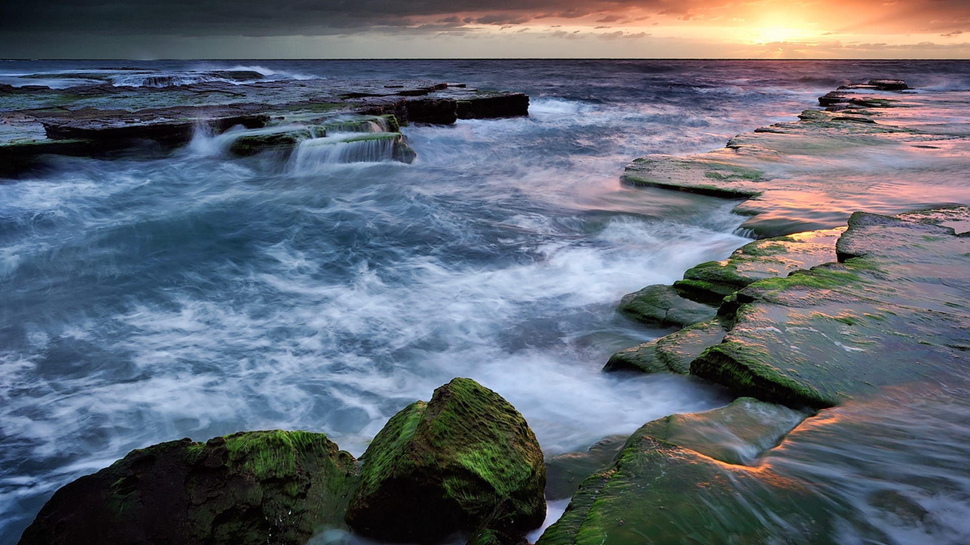 Ocean sunset over rocky coastline HD Wallpaper