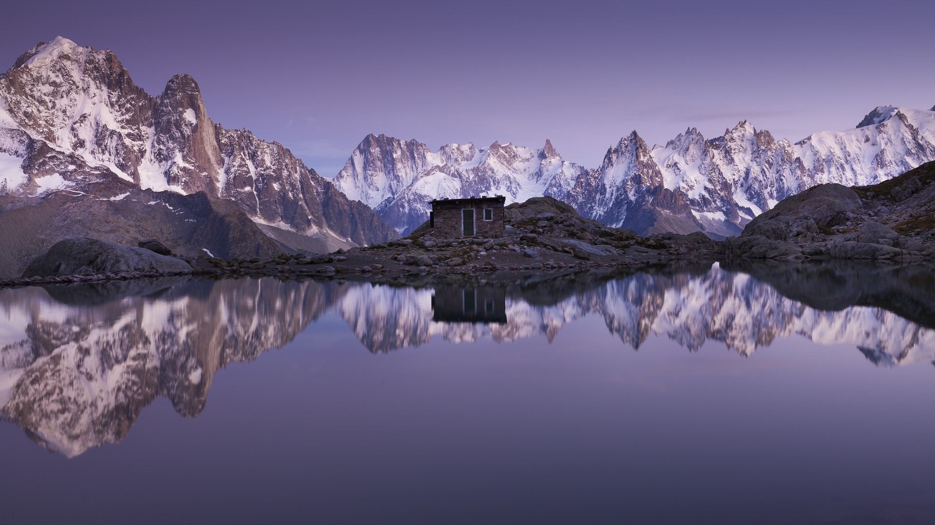 Mountain Range Reflected in Lake with Small Cabin HD Wallpaper