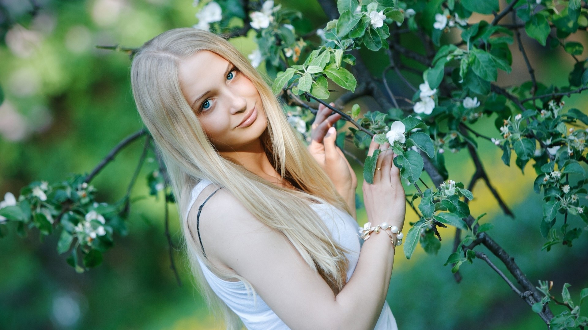 Young woman with blonde hair near blooming tree HD Wallpaper