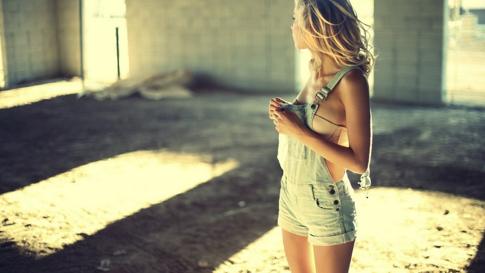 Woman in denim overalls in abandoned building HD Wallpaper