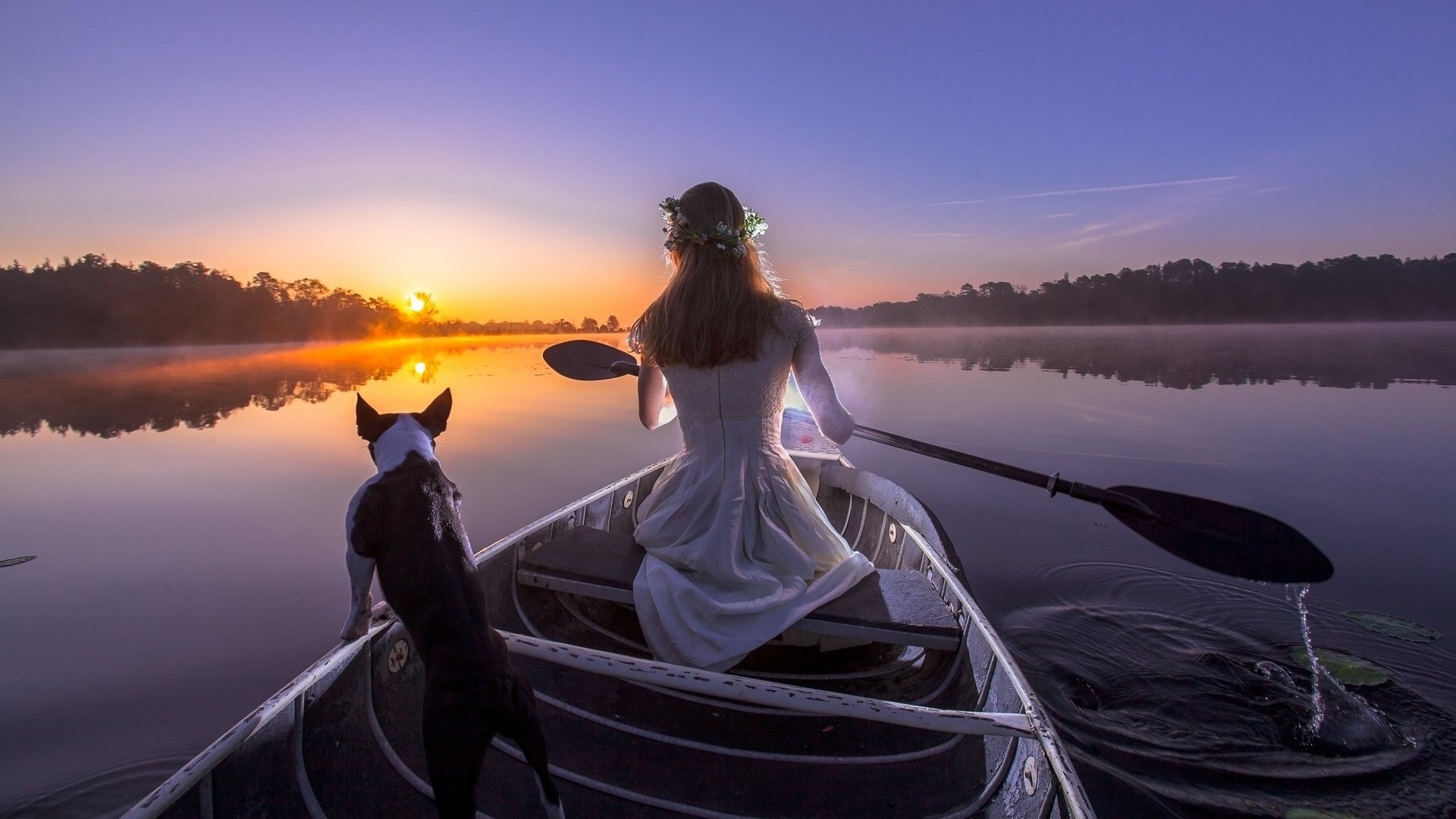 Woman and dog in a canoe at sunrise HD Wallpaper