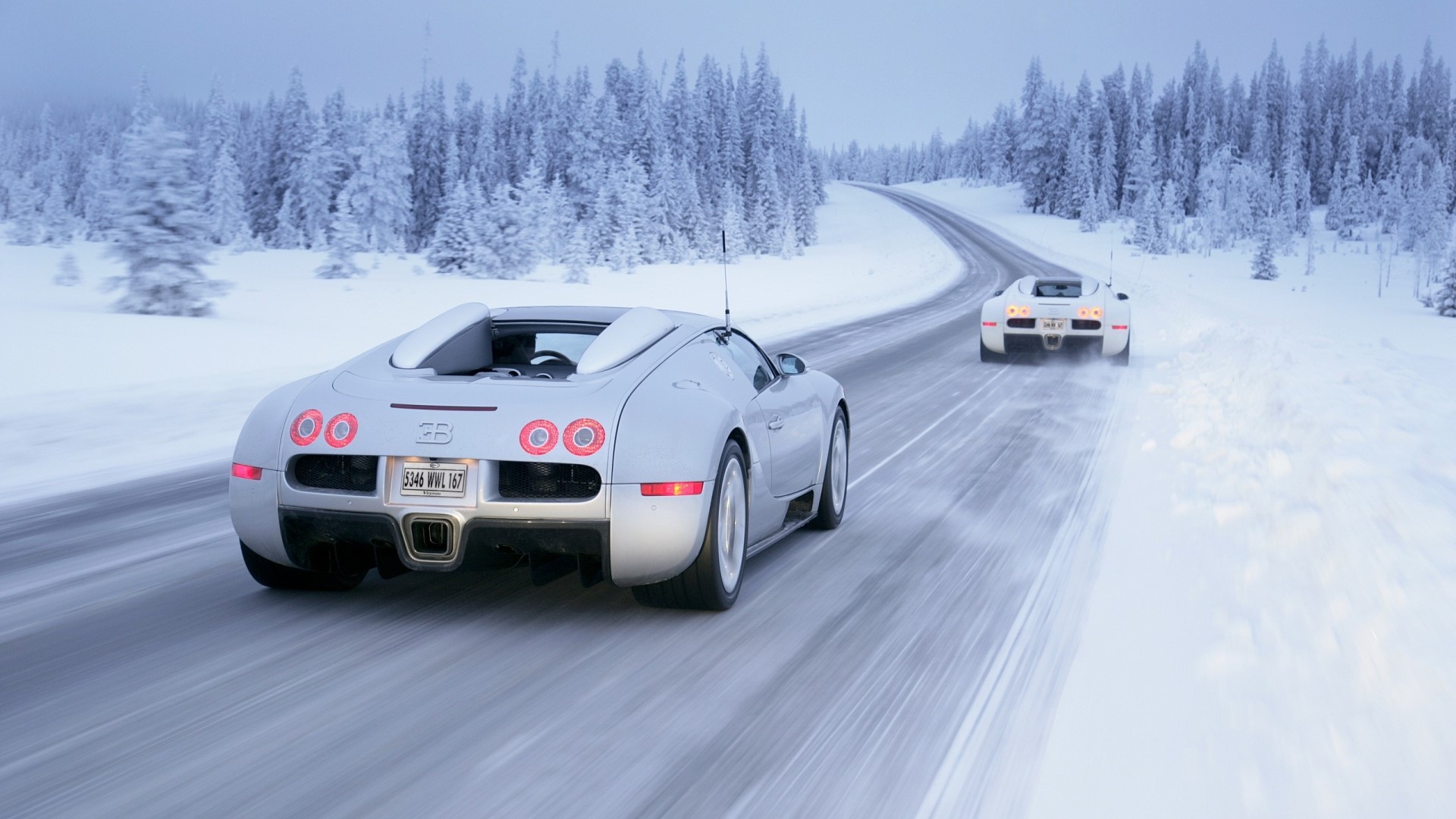 Bugatti Veyron cars driving on a snowy road HD Wallpaper