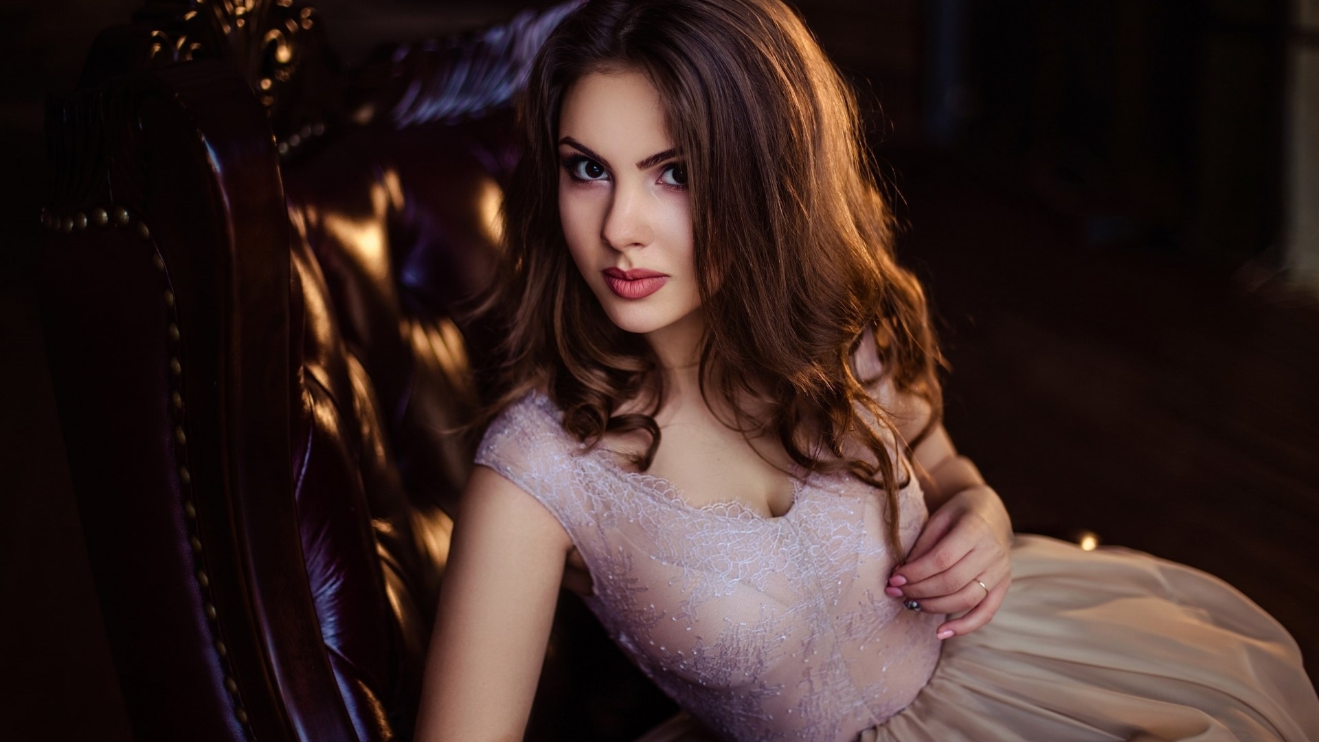 Young woman in a dress sitting in a chair HD Wallpaper