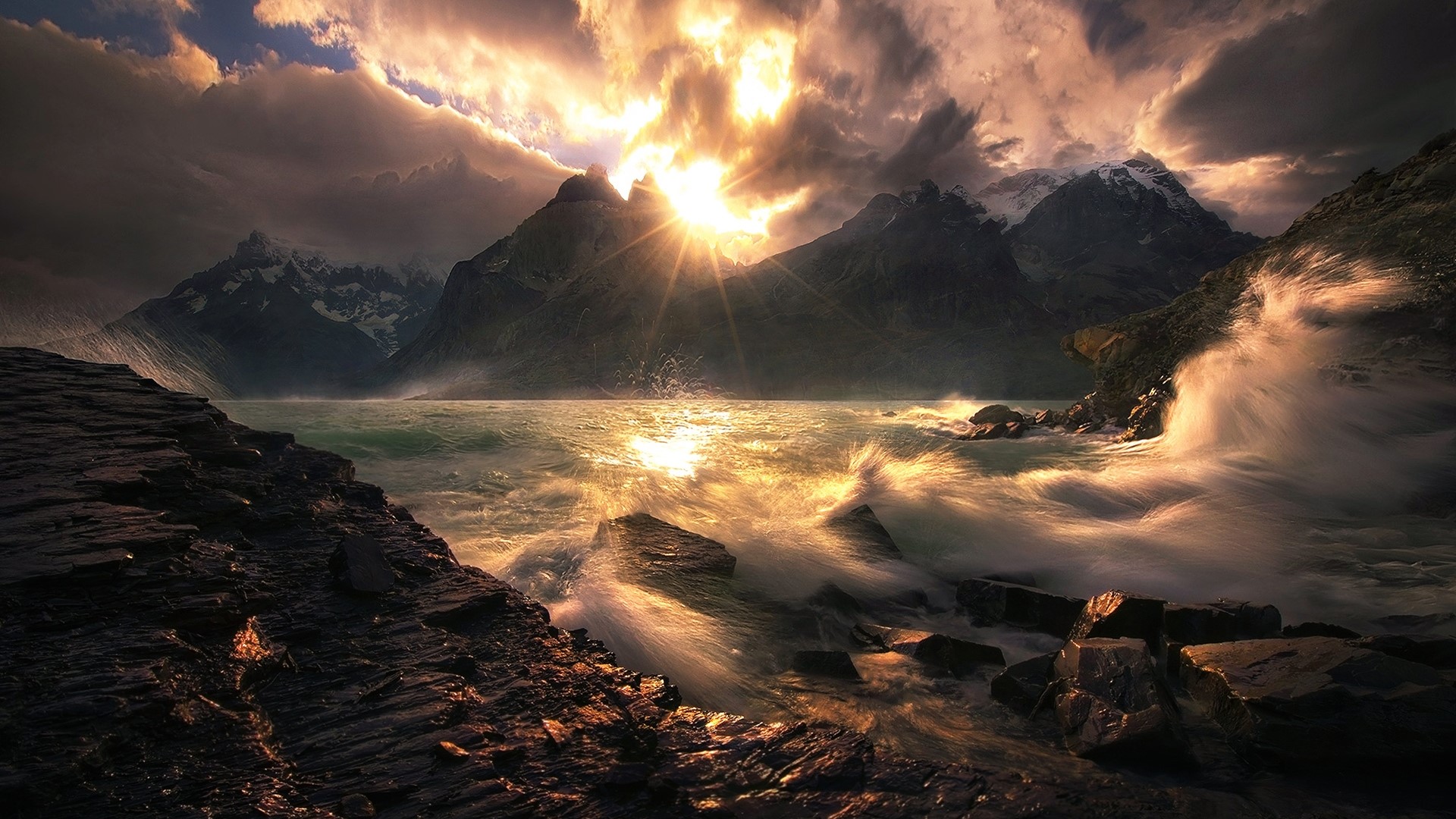Dramatic sunset over stormy ocean and mountains HD Wallpaper