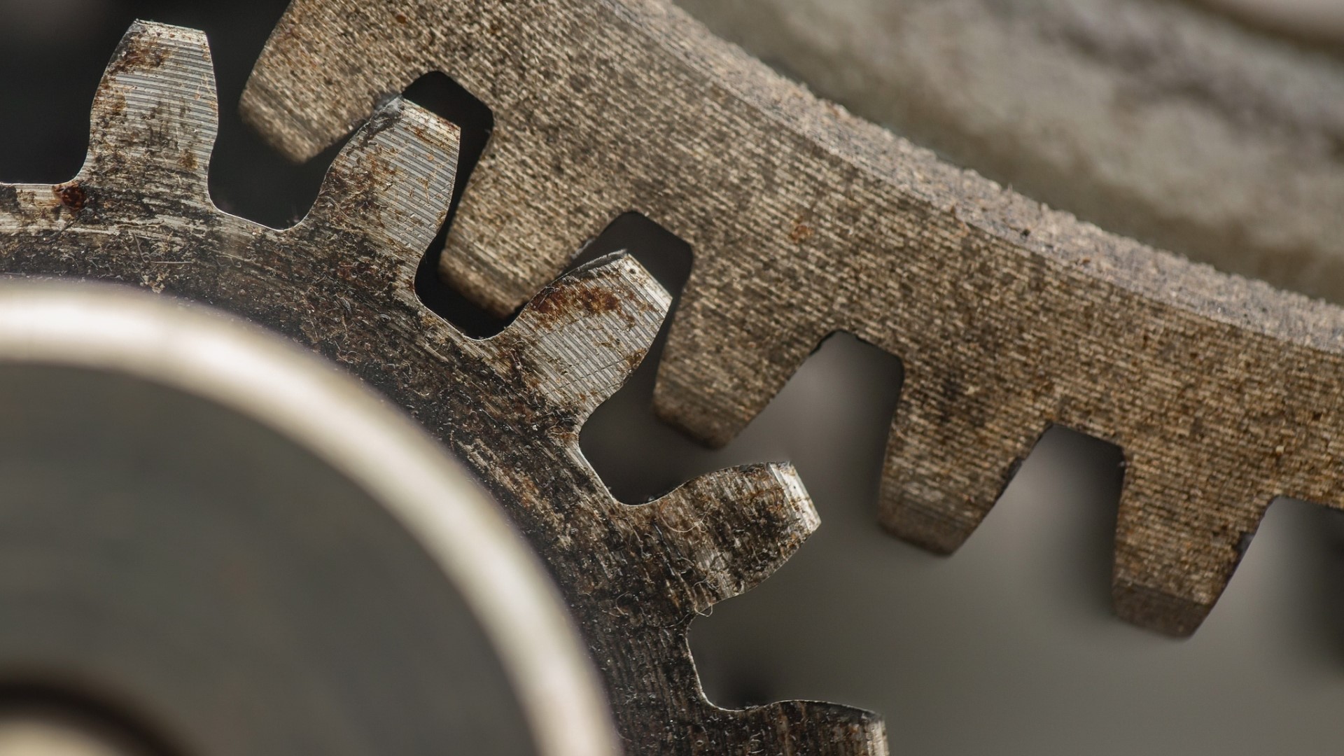 Close-up of two rusty metal gears HD Wallpaper