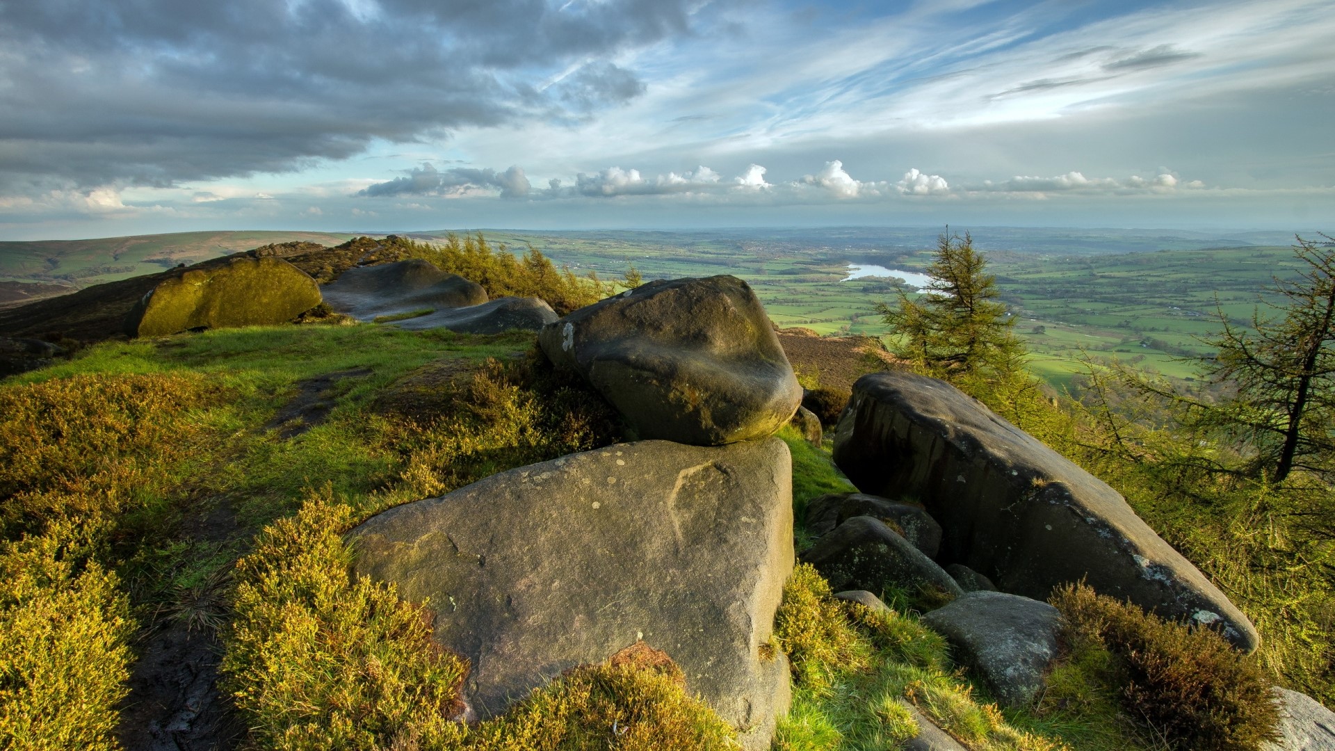 Rocky outcrop overlooking a valley with a river HD Wallpaper