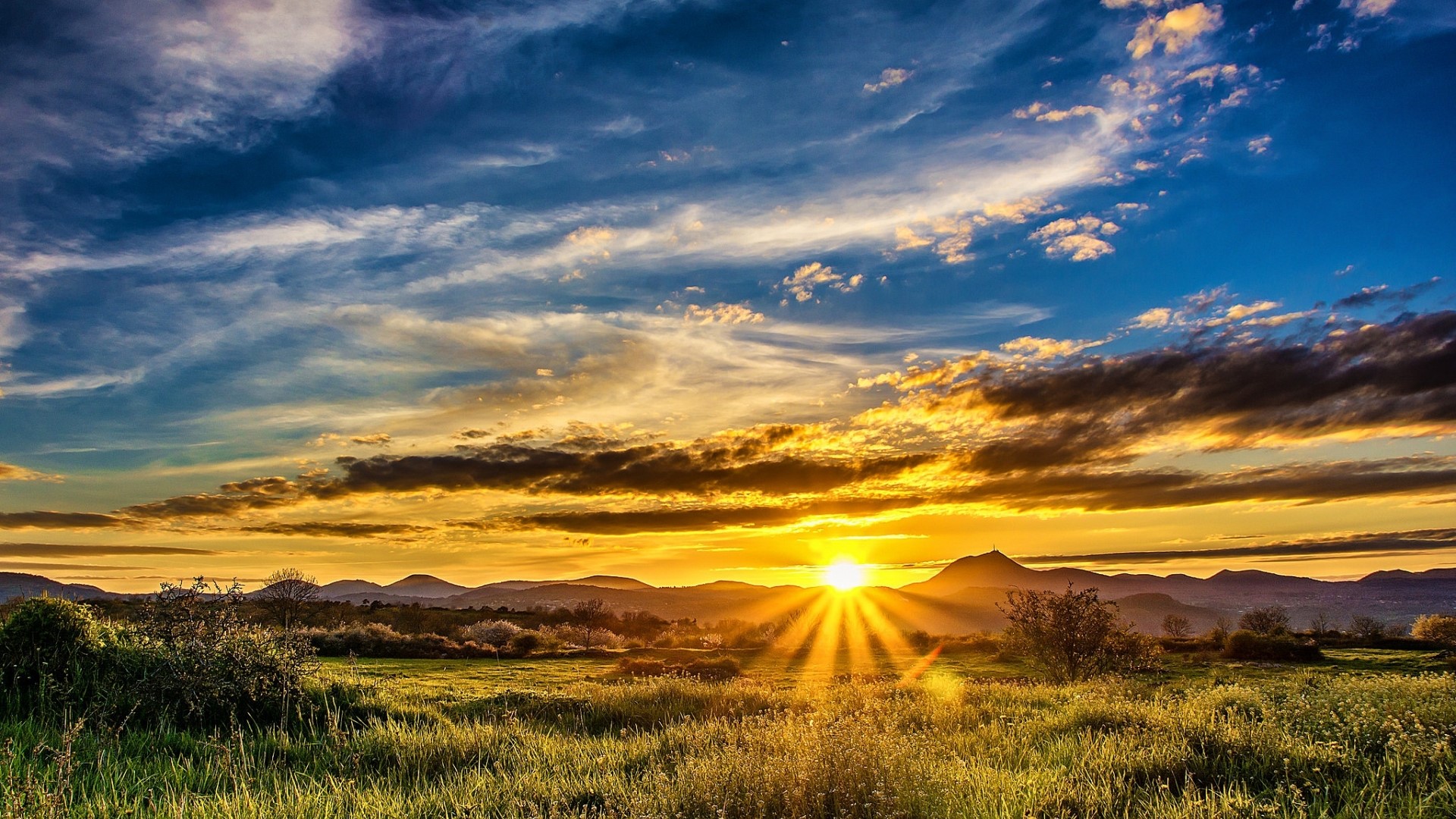 Sunset over rolling hills and grassy fields HD Wallpaper