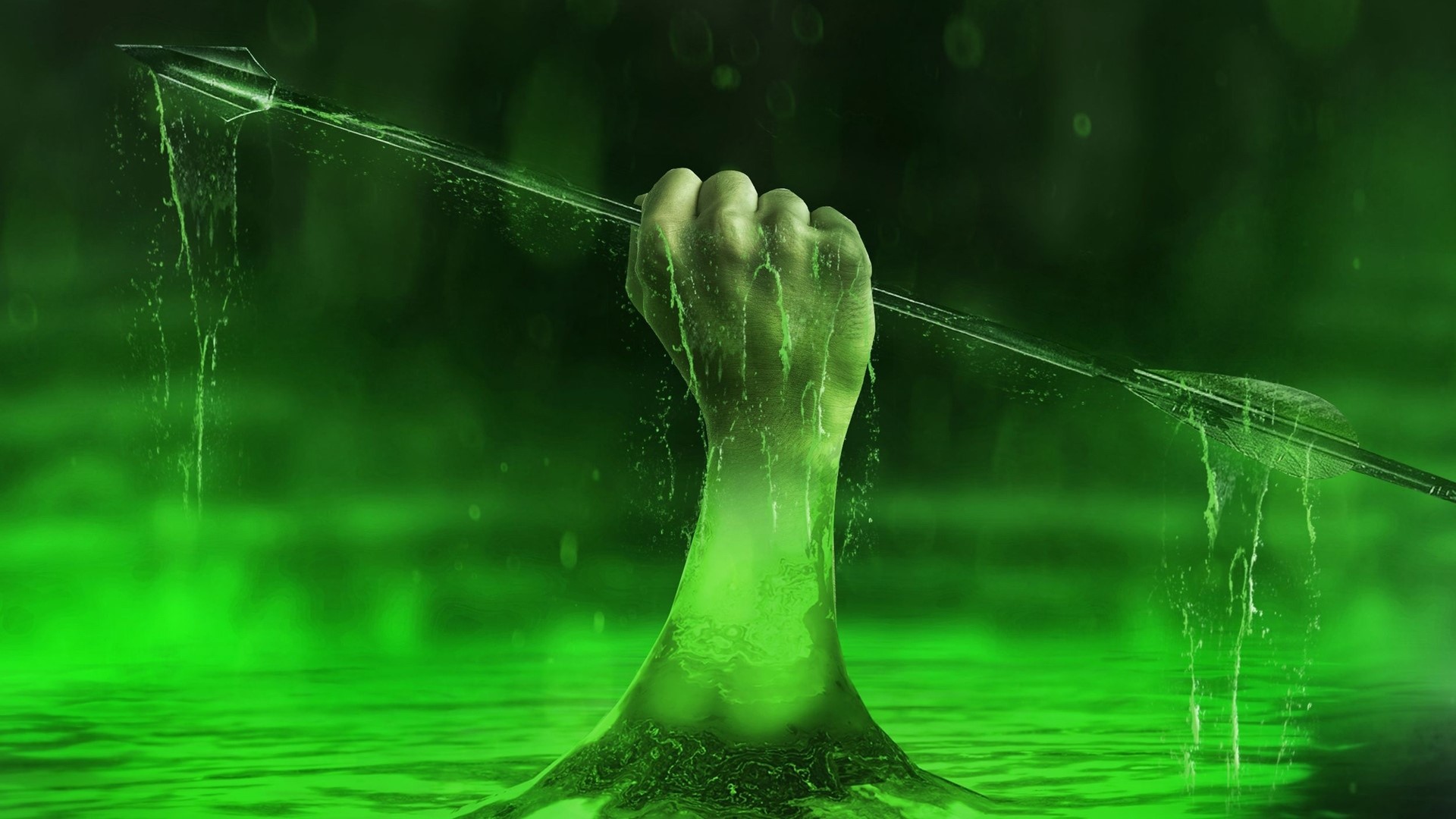 Hand holding an arrow emerging from green liquid HD Wallpaper