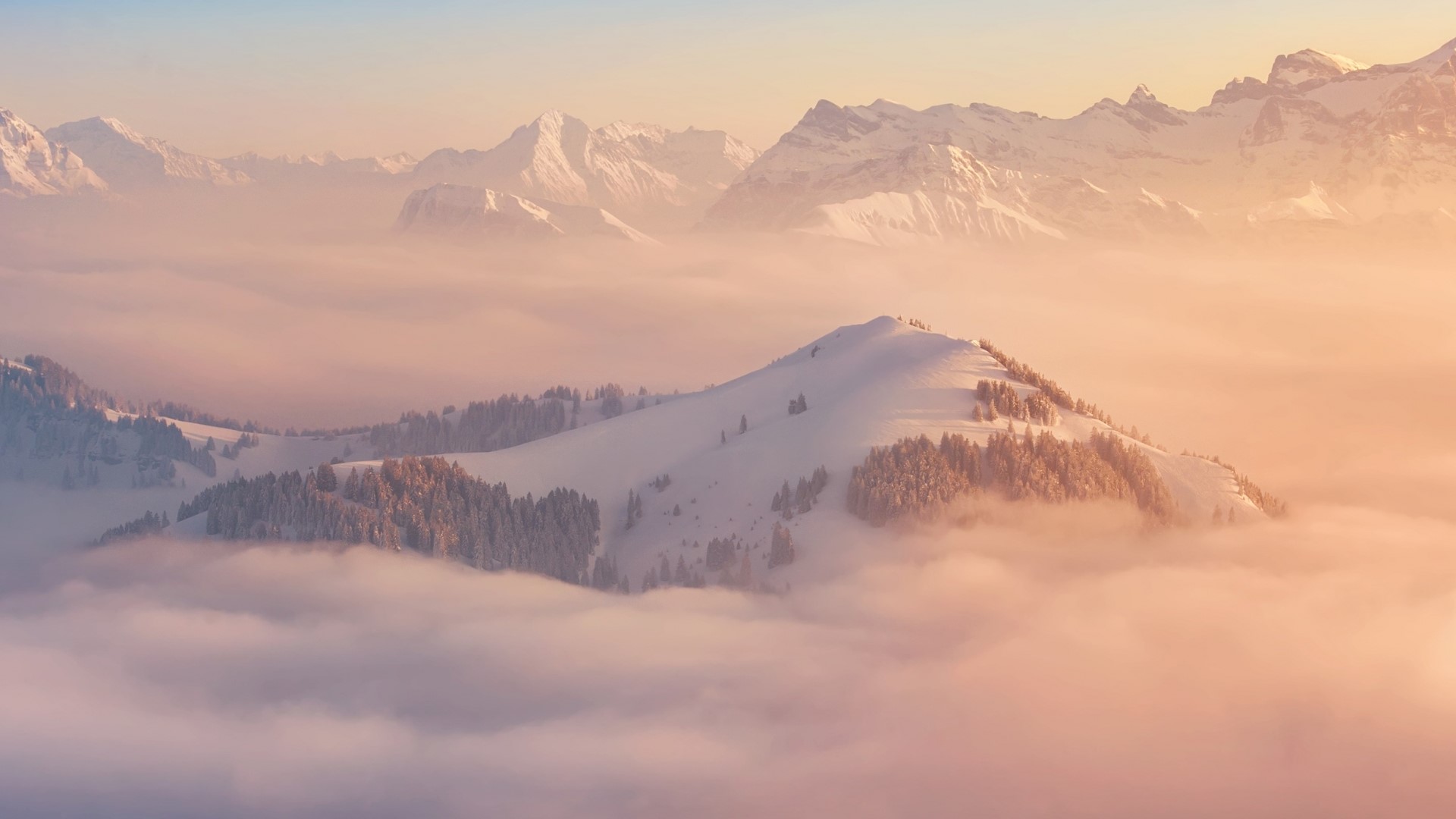 Snowy mountains above clouds at sunrise HD Wallpaper