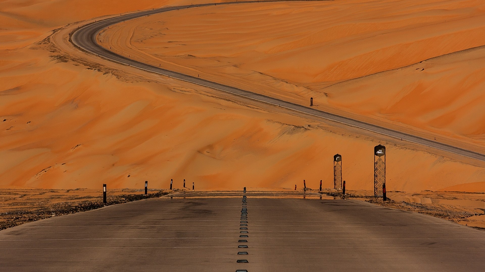 Desert road with sand dunes and lights HD Wallpaper