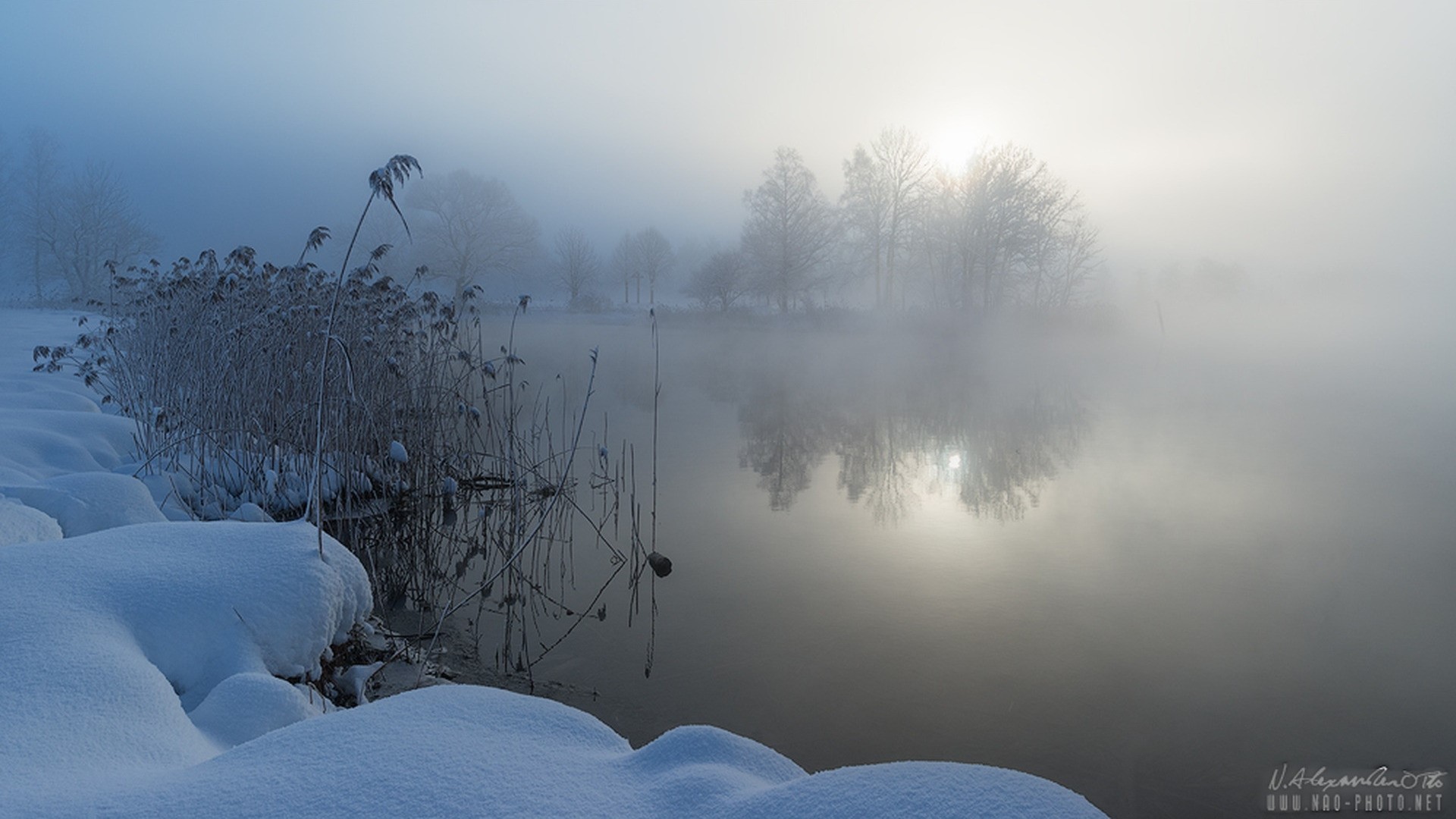 Winter fog over a lake with snow-covered shore HD Wallpaper