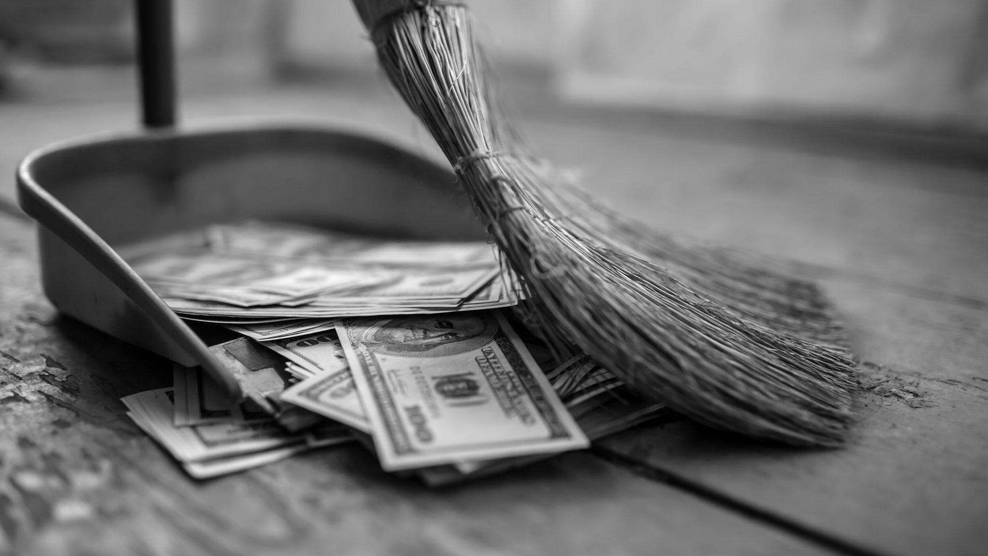 Money in a dustpan with a broom HD Wallpaper