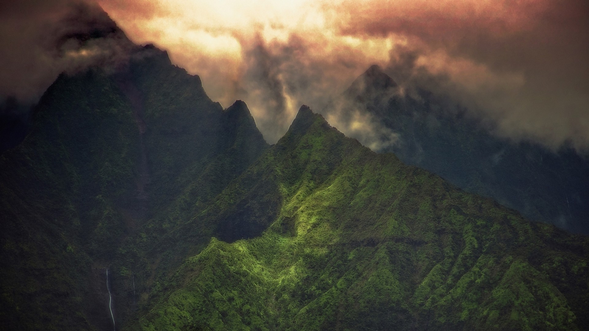 Jagged green mountains shrouded in clouds HD Wallpaper