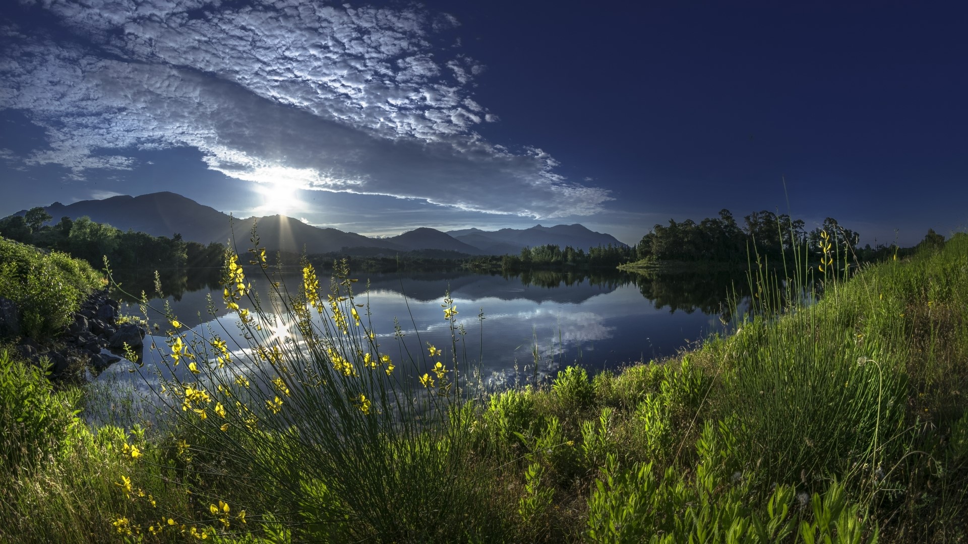 Sunrise over a calm lake with mountains and clouds HD Wallpaper