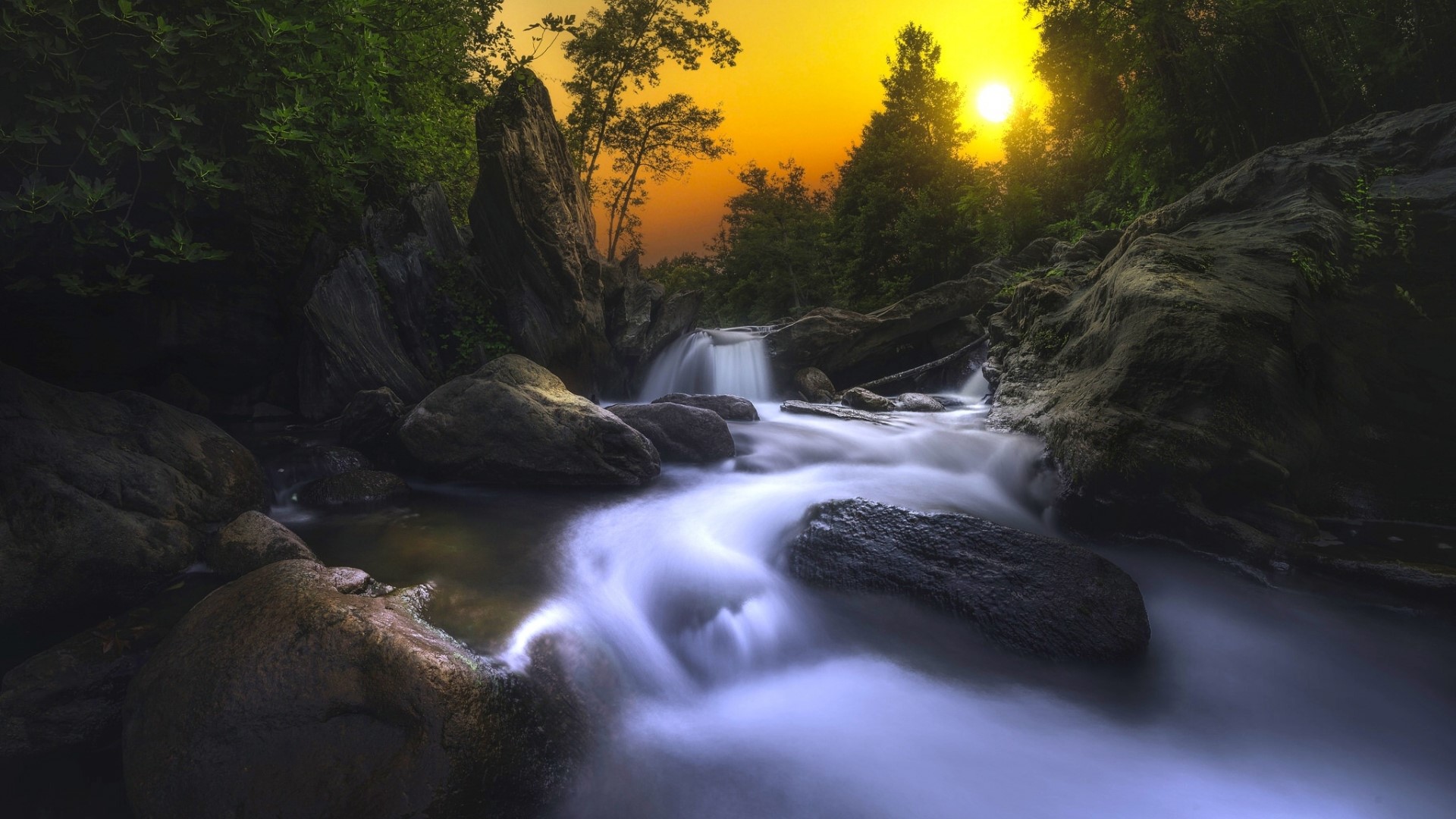 Sunset over a waterfall and stream HD Wallpaper