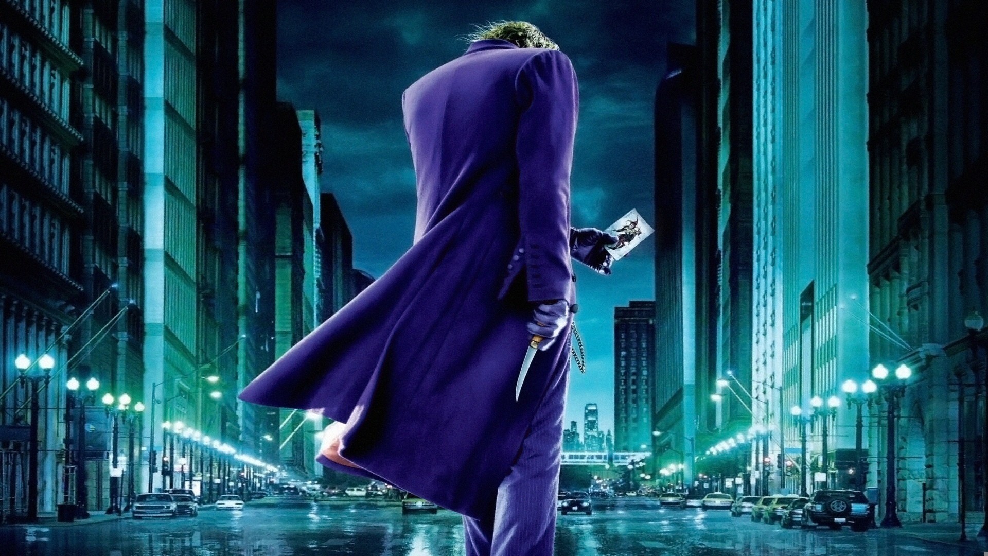 Joker from The Dark Knight holding a playing card and knife HD Wallpaper