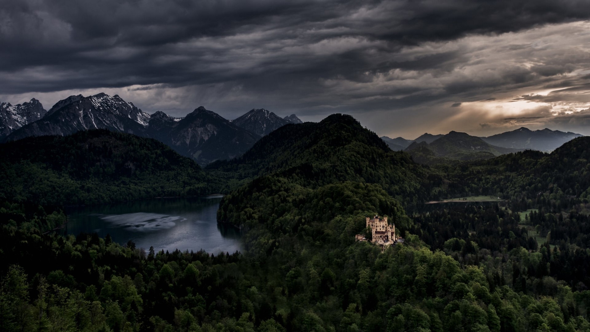 Castle on a hill overlooking a lake and mountains HD Wallpaper