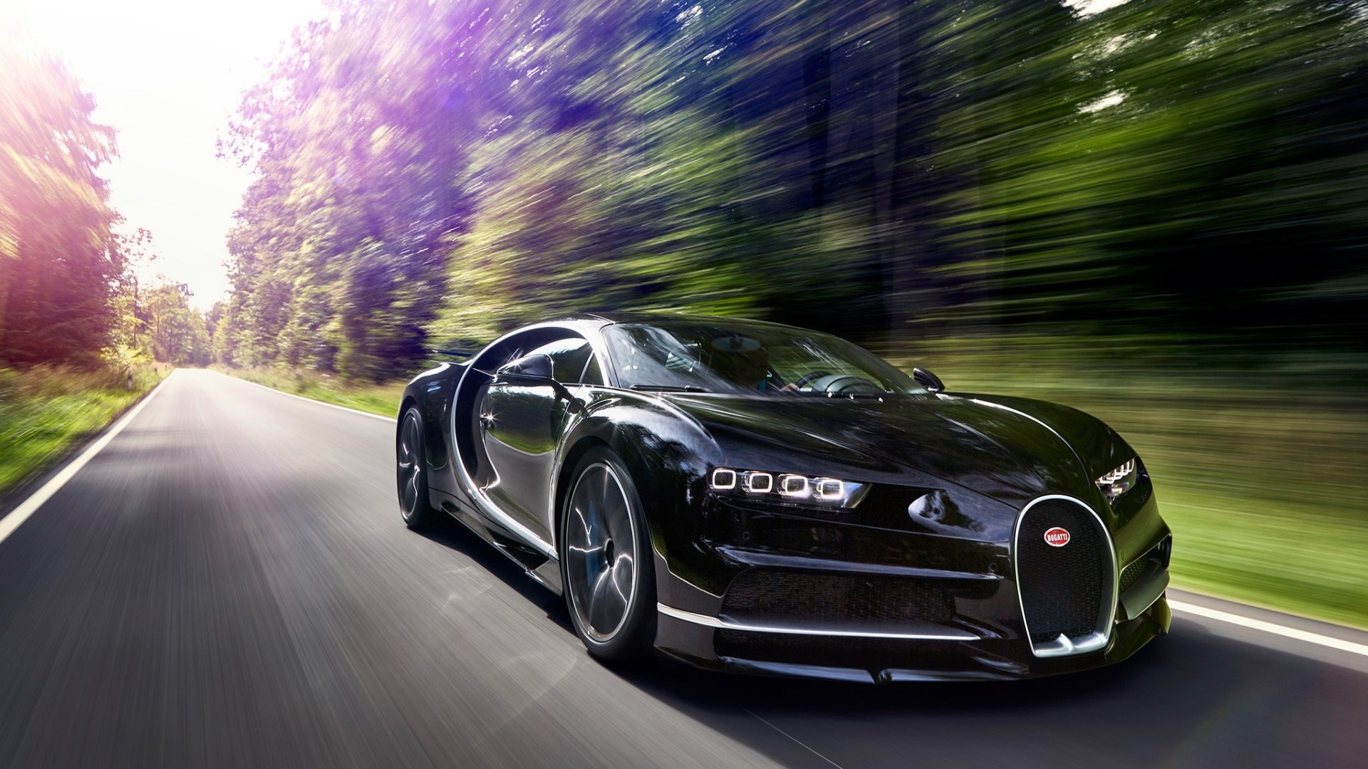 Black Bugatti Chiron driving on a road HD Wallpaper