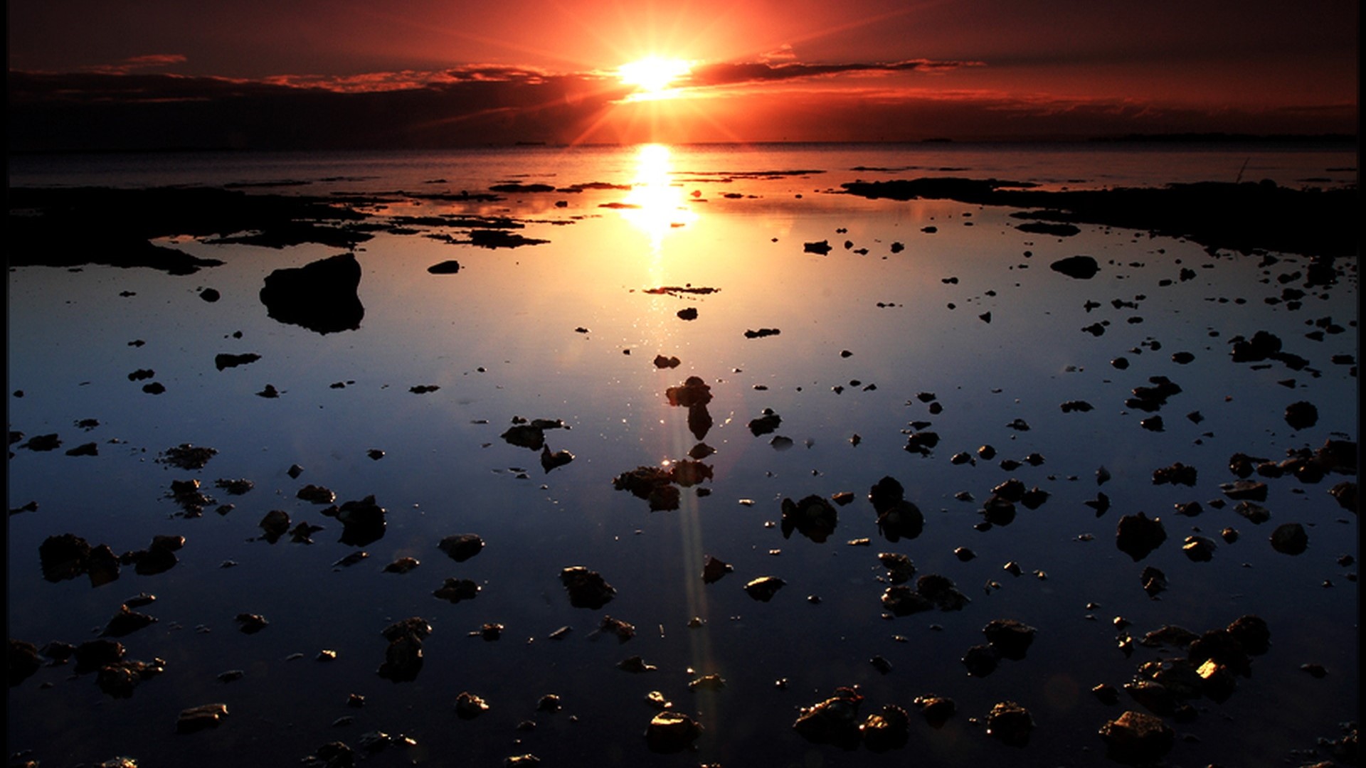 Sunset over the ocean with rocks HD Wallpaper