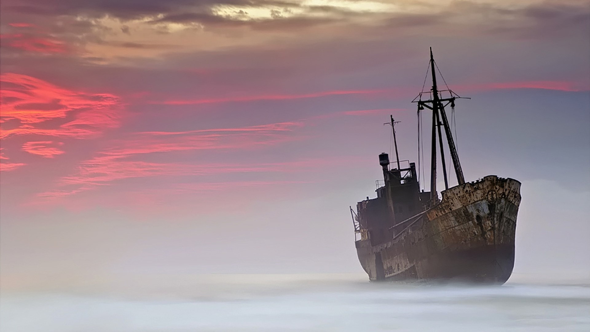 Shipwreck at sunset with colorful clouds HD Wallpaper