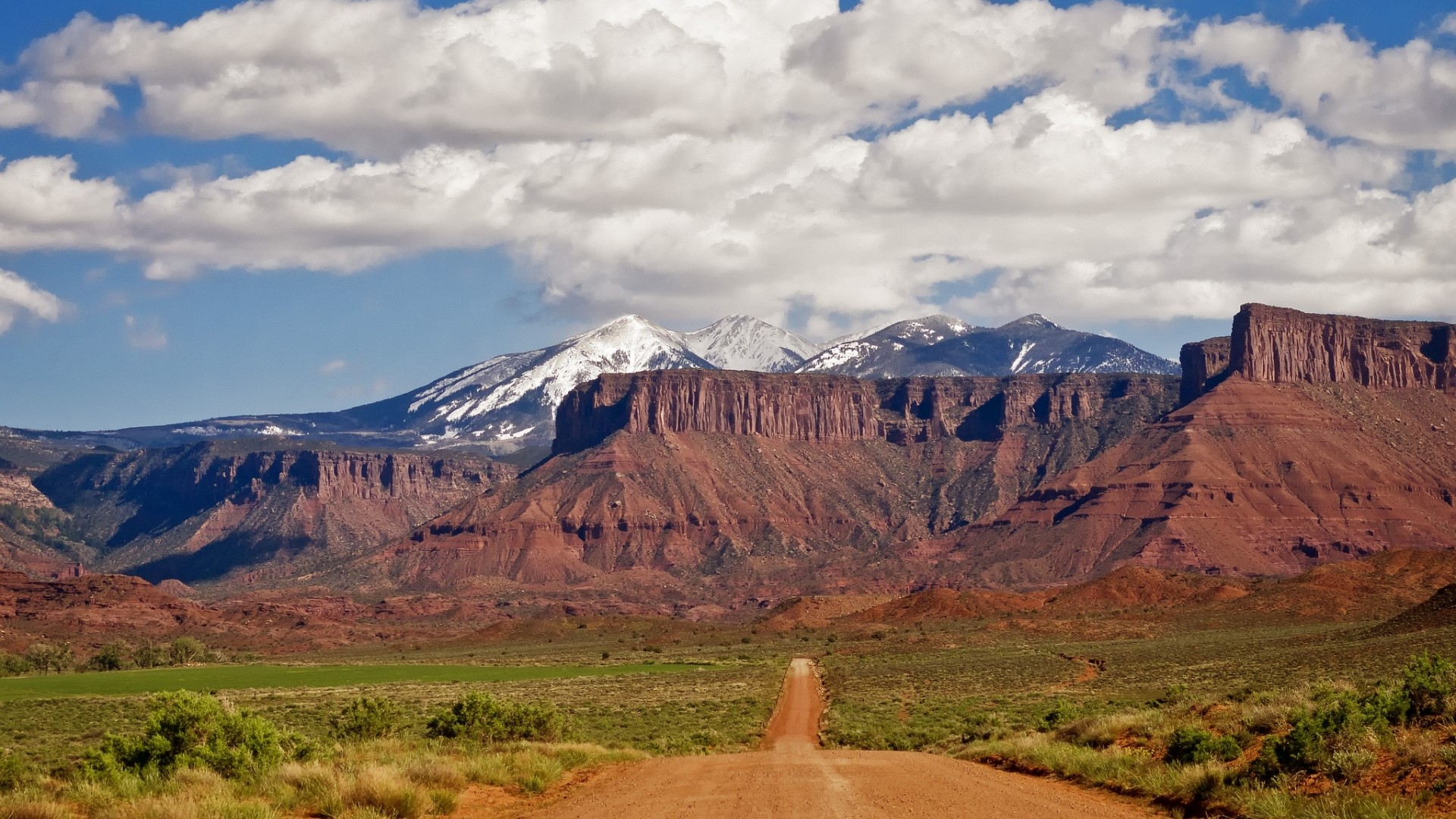 Dirt Road Leading to Snow-Capped Mountains HD Wallpaper