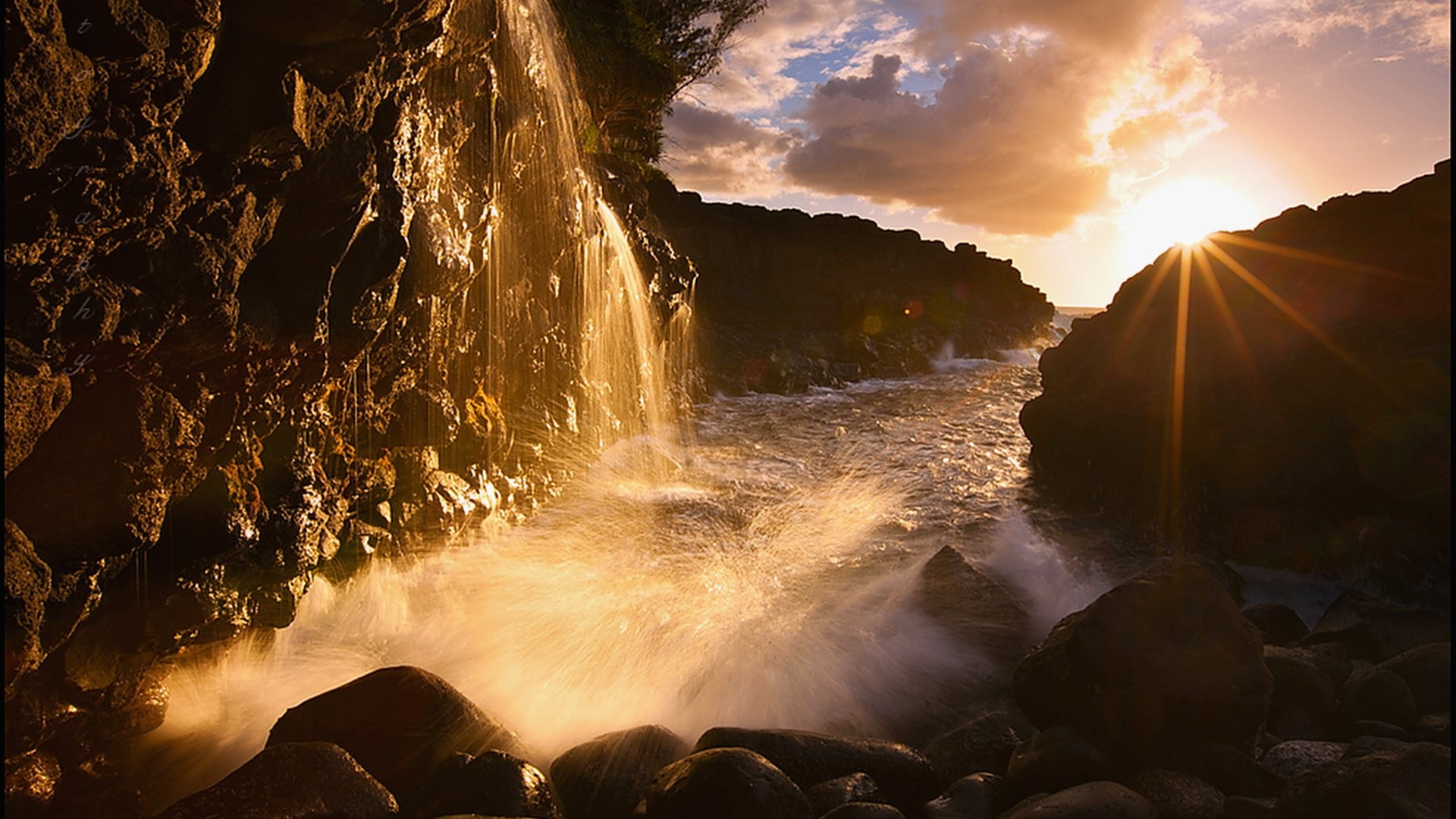 Sunset over rocky coast with waterfall and waves HD Wallpaper