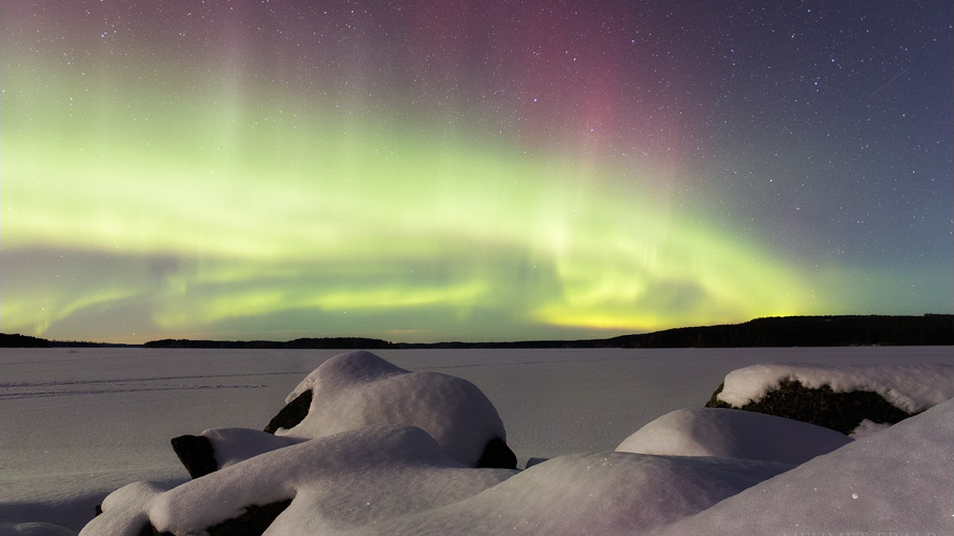 Aurora Borealis over a Snowy Landscape HD Wallpaper