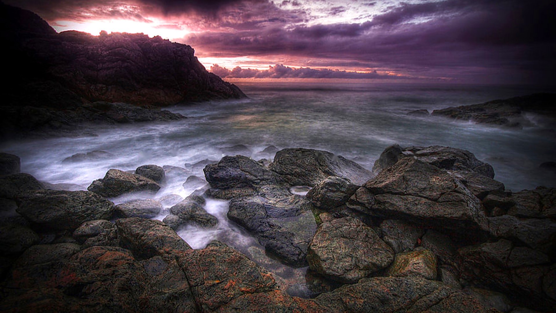 Rocky shore with ocean waves at sunset HD Wallpaper