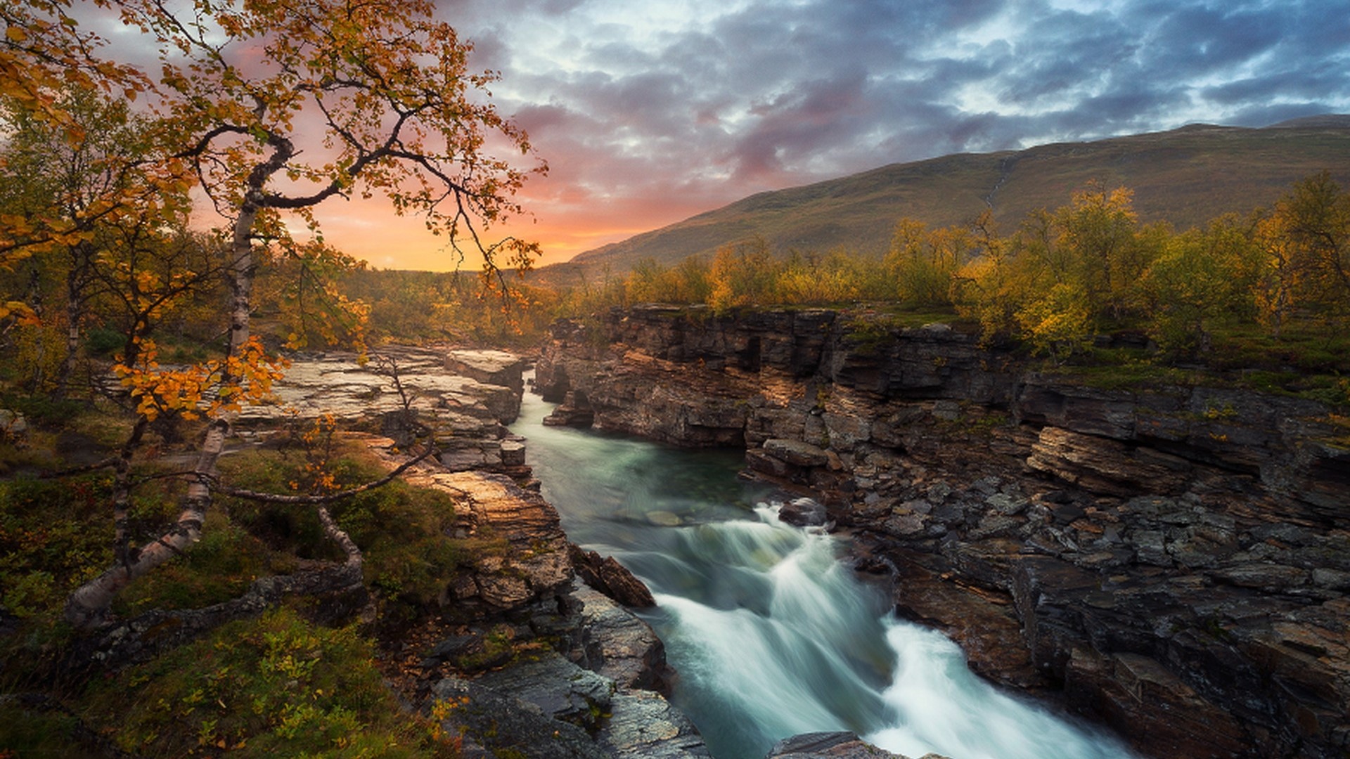 River flowing through a rocky gorge during autumn sunset HD Wallpaper