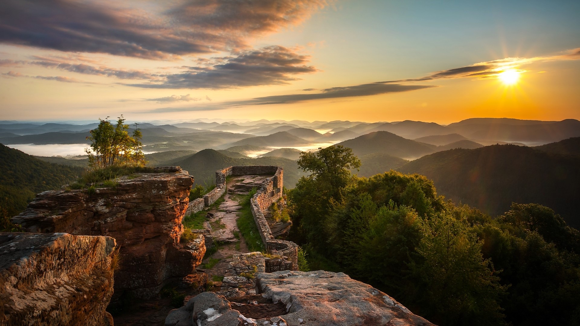 Sunrise over misty mountains and ancient ruins HD Wallpaper