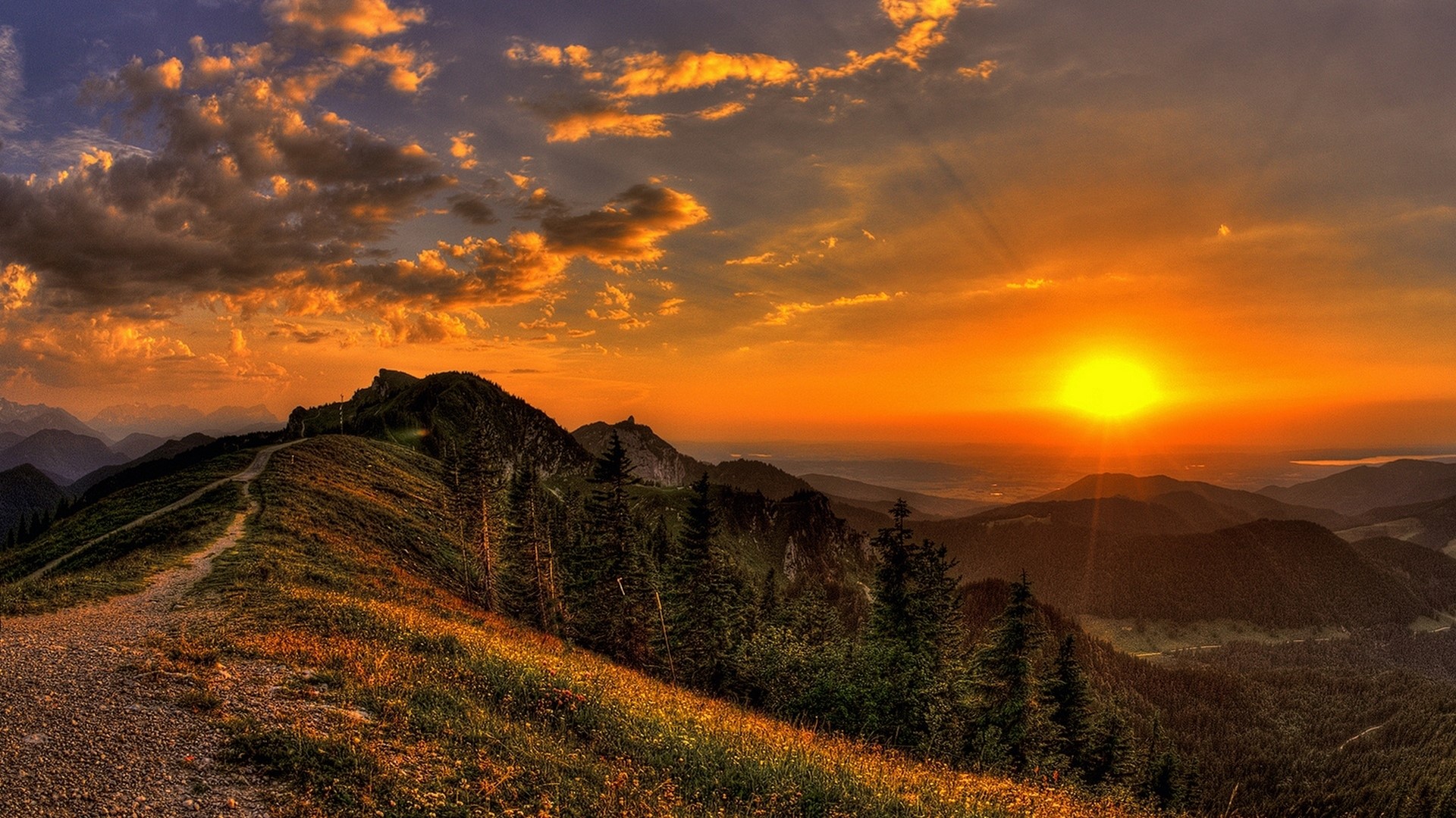 Sunset over mountains with a path HD Wallpaper
