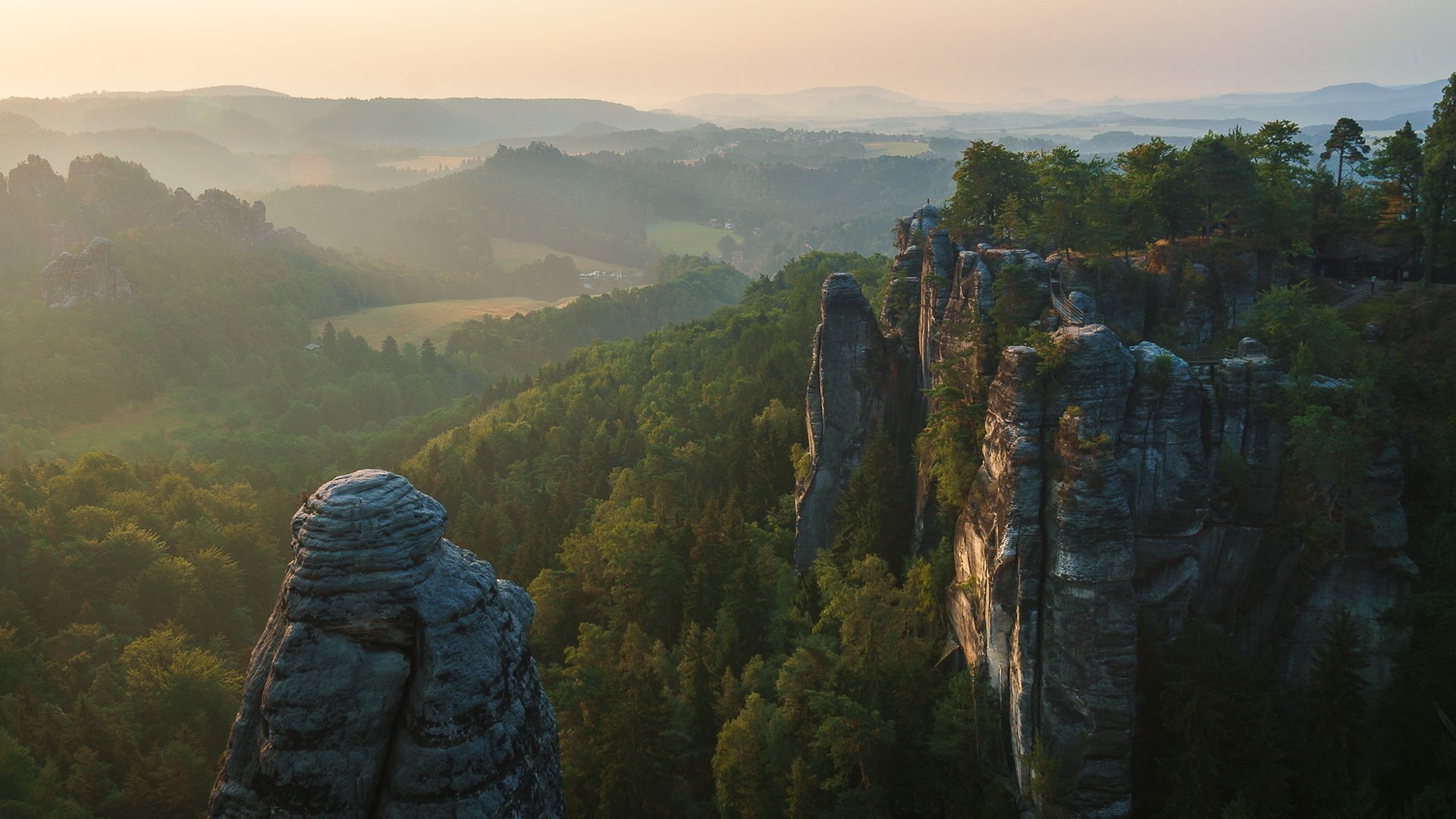 Misty mountain landscape with rock formations HD Wallpaper
