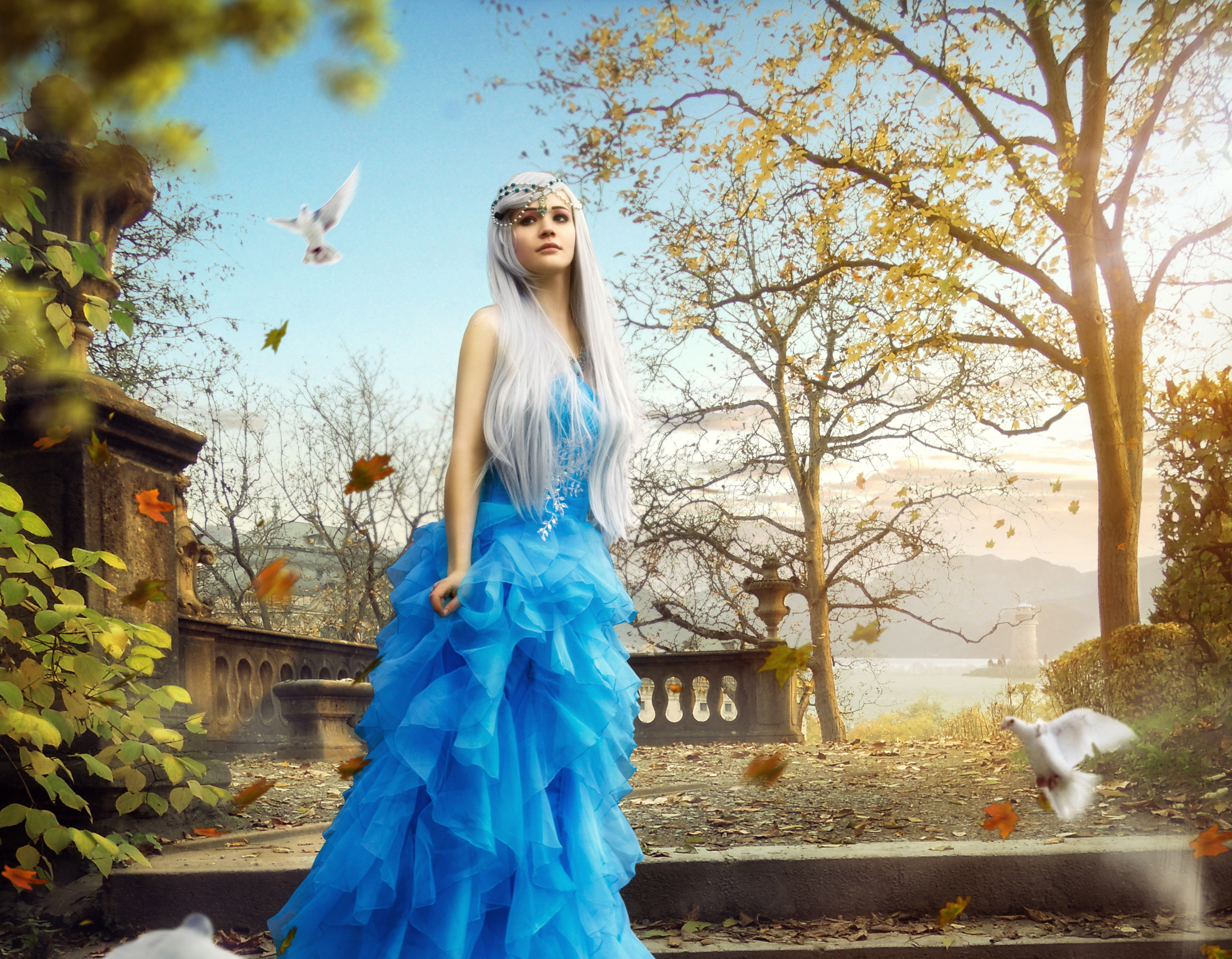Woman in blue dress with doves in autumn park HD Wallpaper