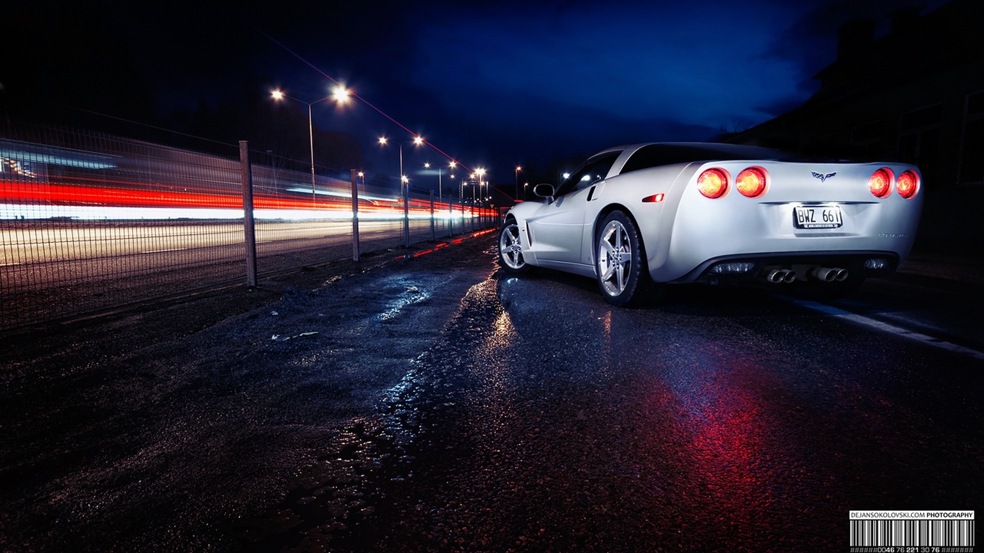 Silver Corvette parked on wet road at night HD Wallpaper