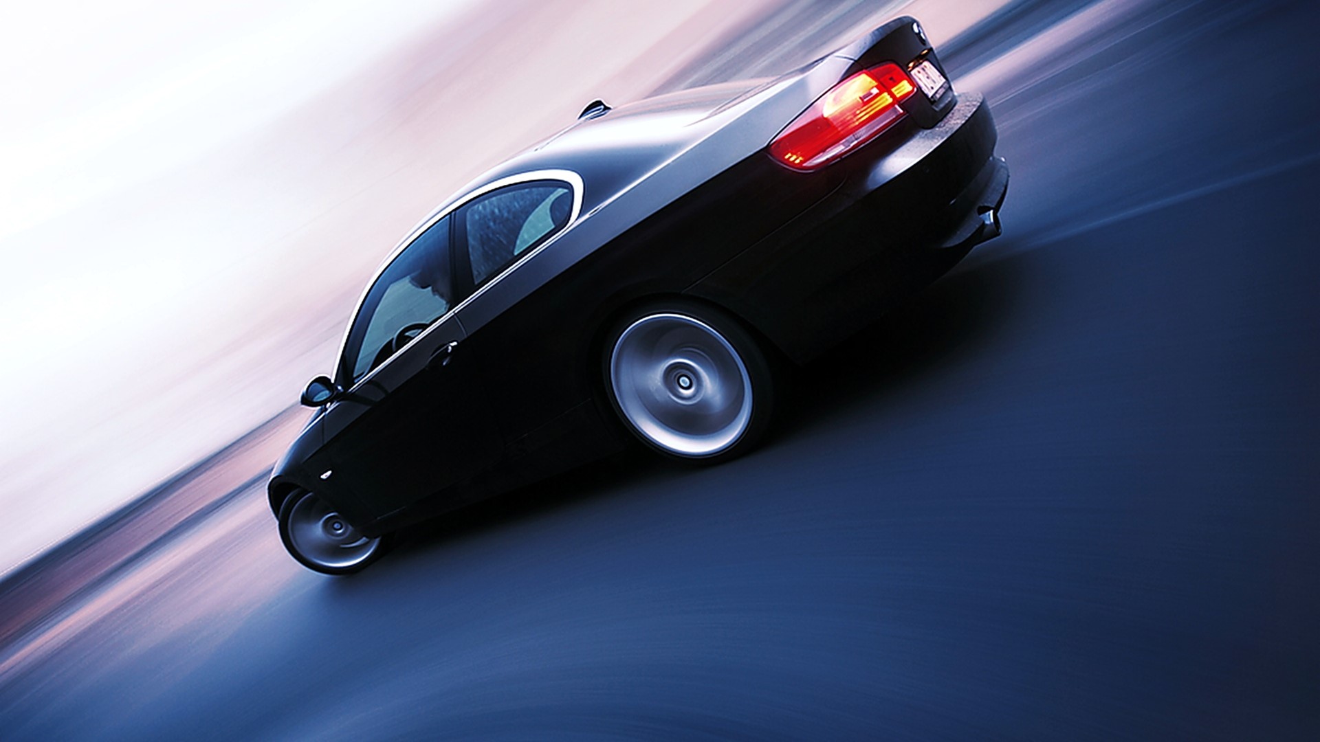 Black BMW coupe driving on a blurred road HD Wallpaper