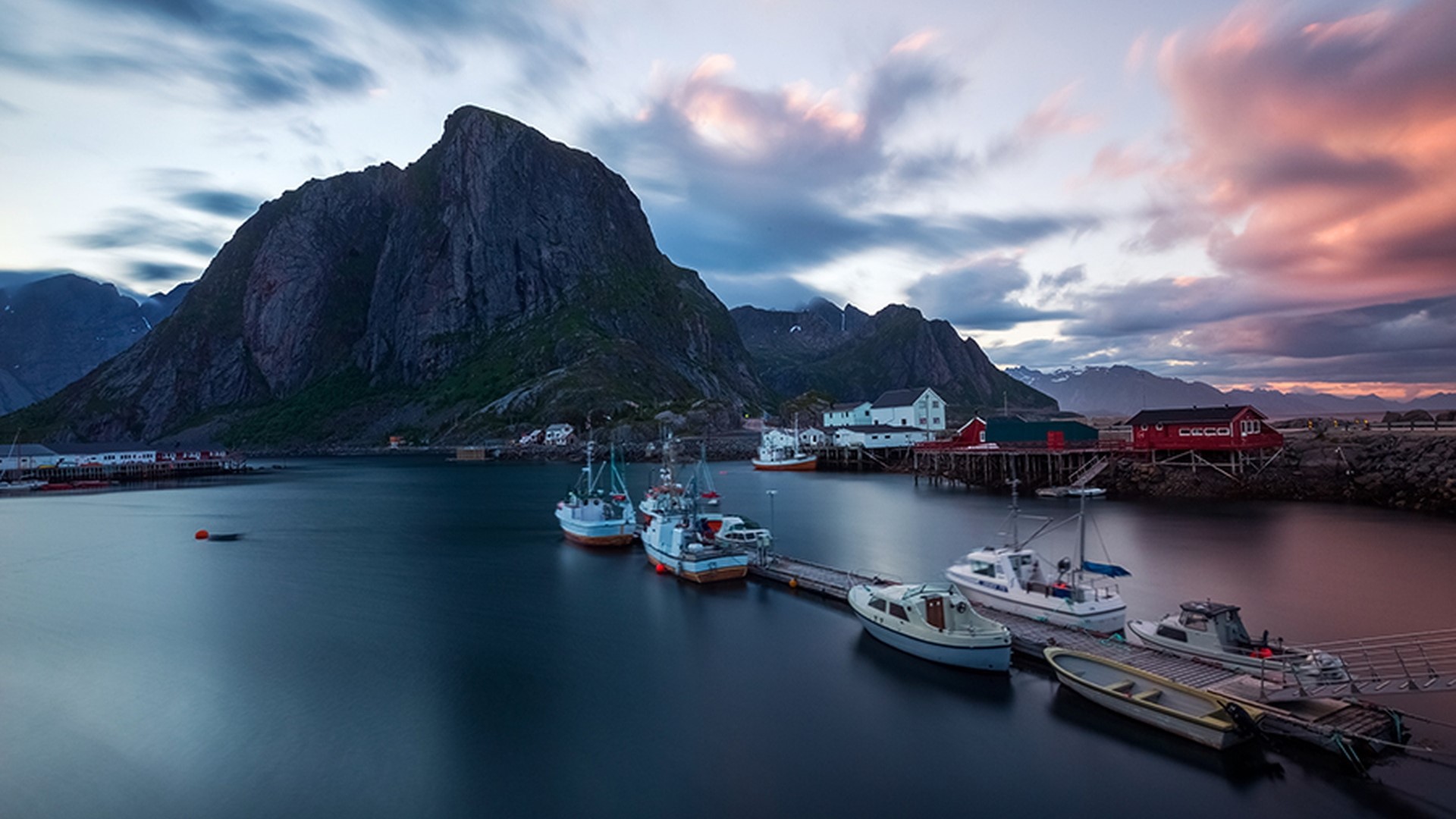 Fishing boats docked in a harbor with a mountain backdrop HD Wallpaper