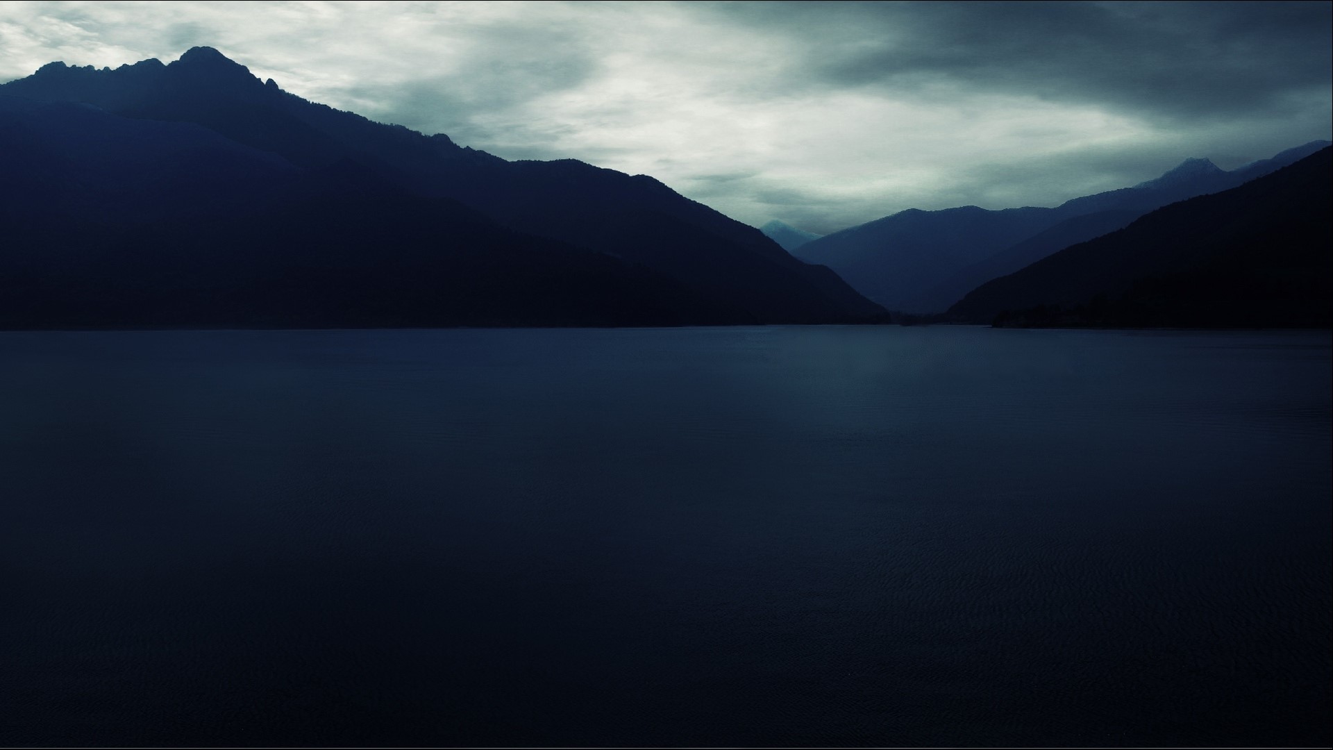Dark Mountains Overlooking a Calm Lake HD Wallpaper