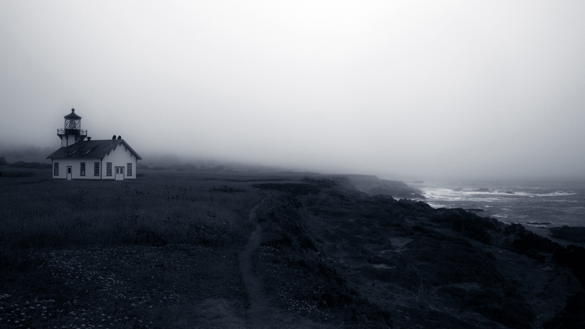 Lighthouse on a foggy coast HD Wallpaper