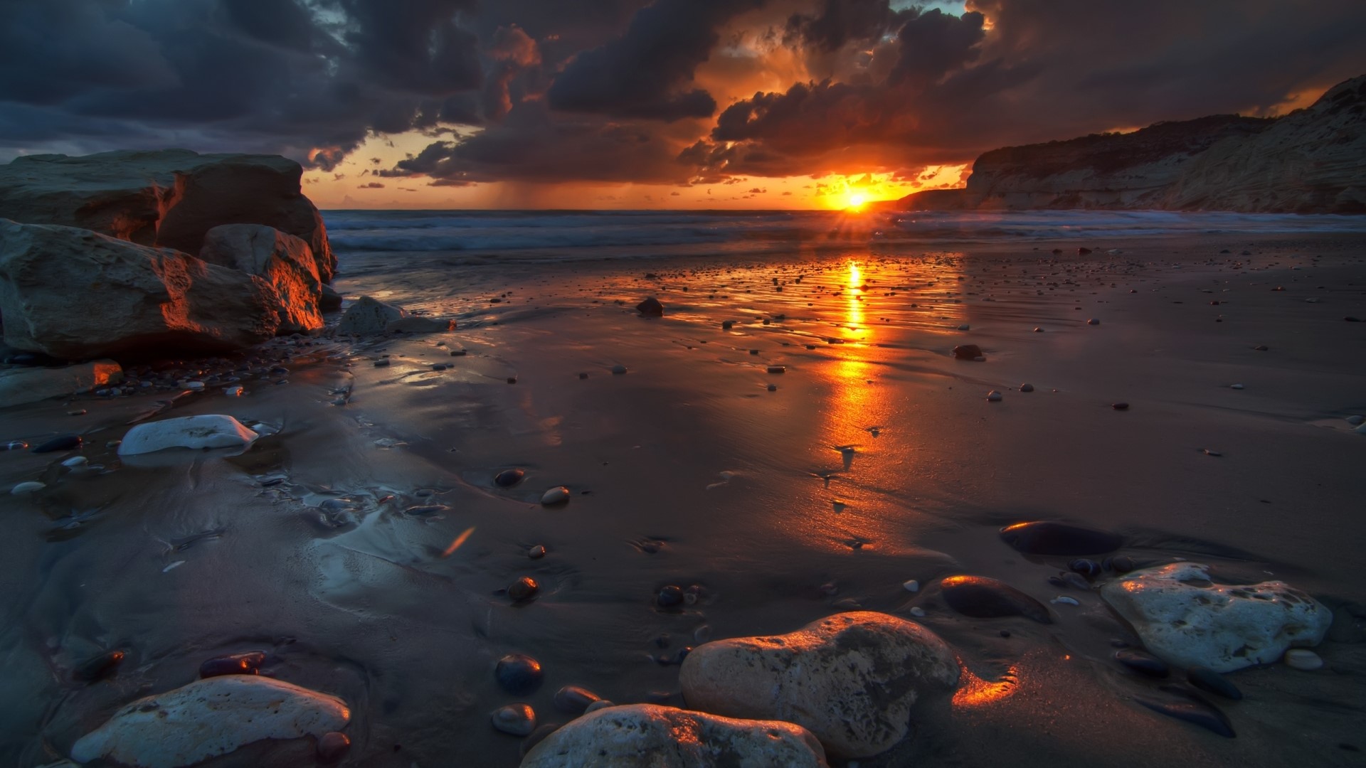 Sunset over a rocky beach HD Wallpaper