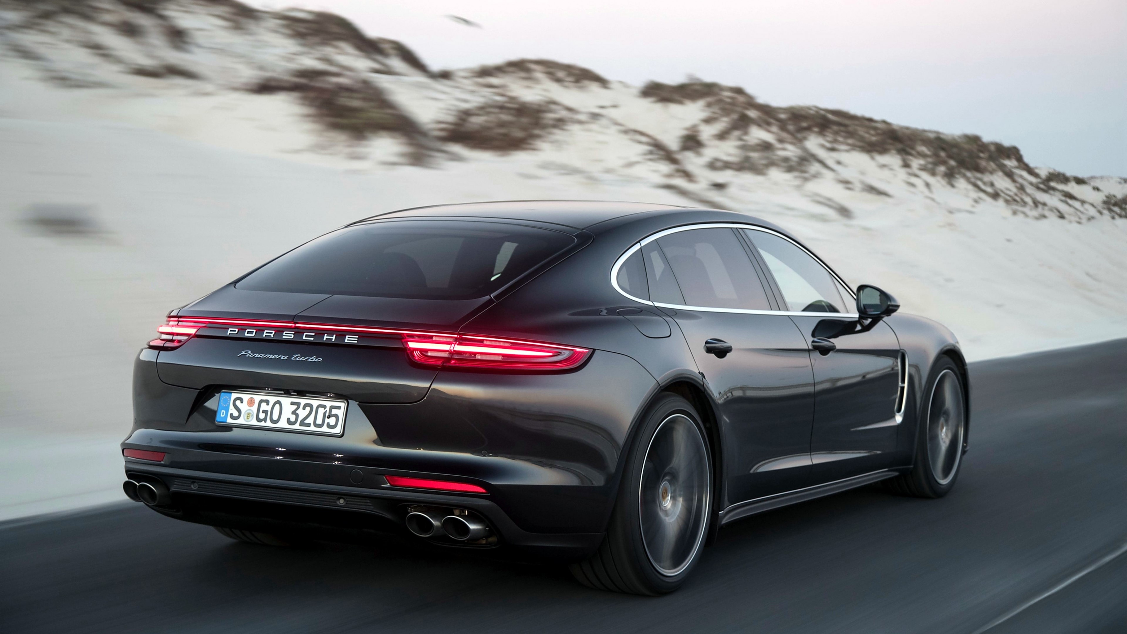 Porsche Panamera Turbo driving on a road HD Wallpaper