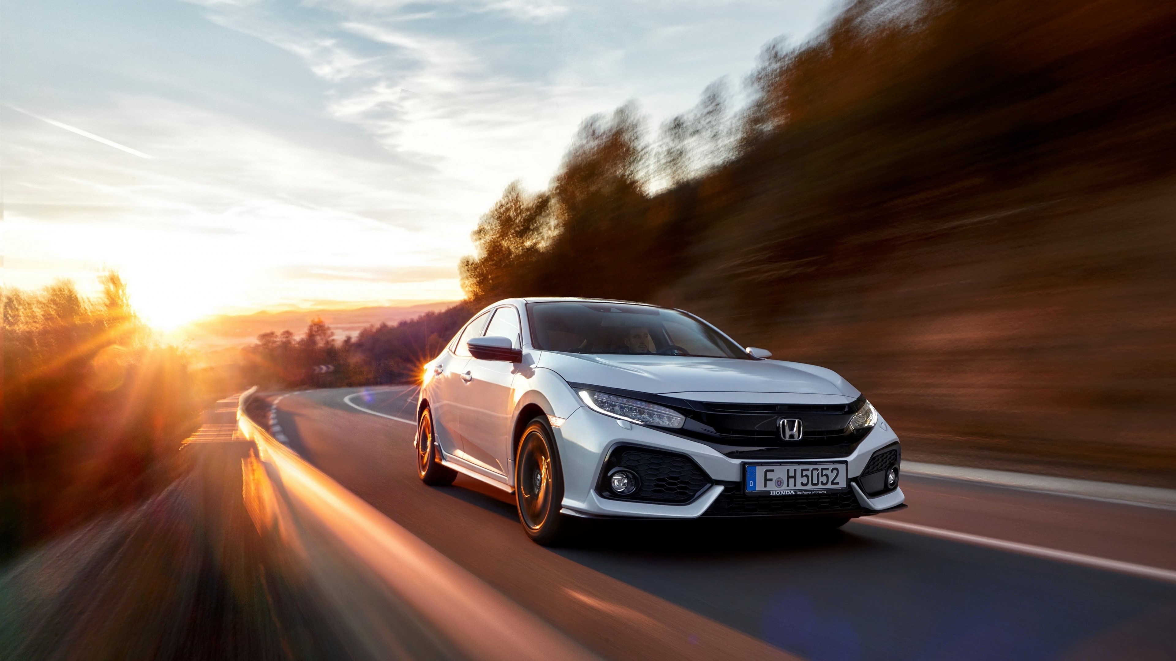 White Honda Civic driving on a winding road at sunset HD Wallpaper