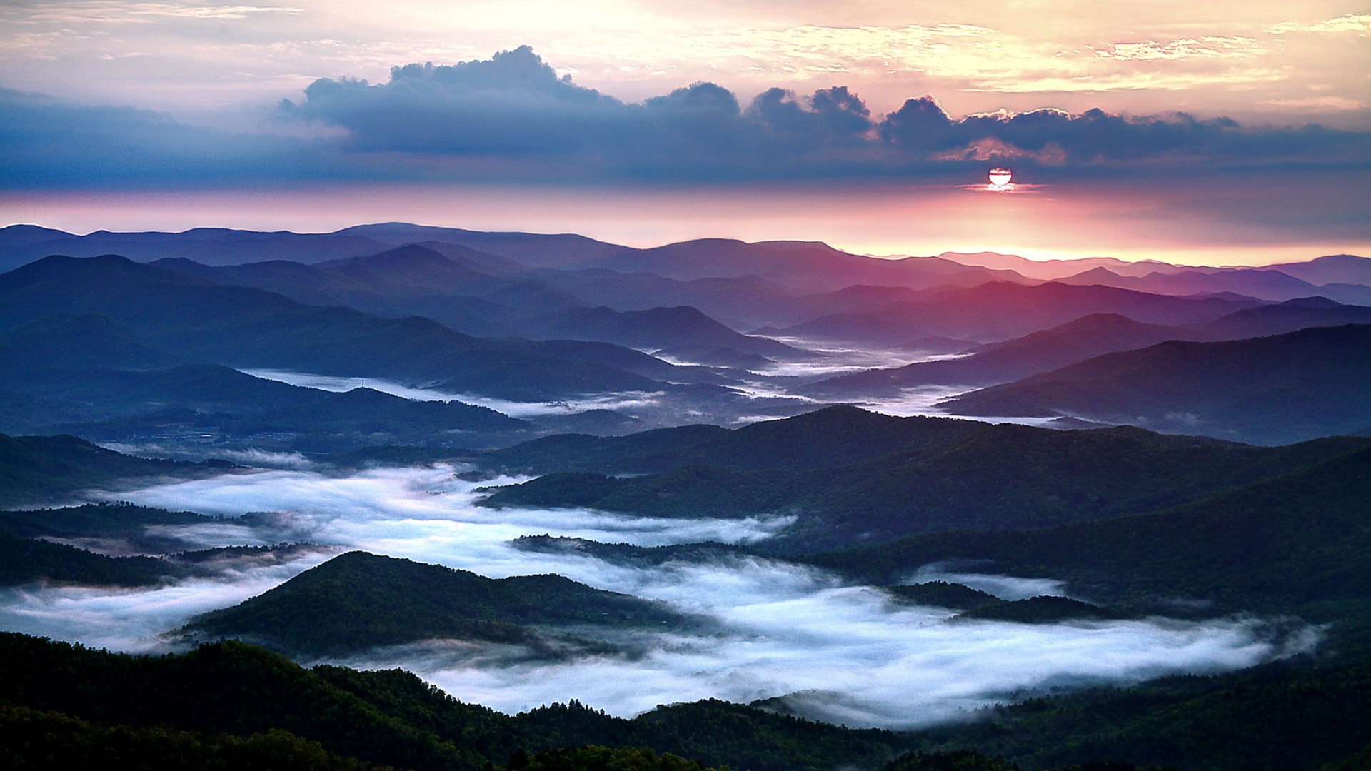 Mountain range at sunrise with fog HD Wallpaper